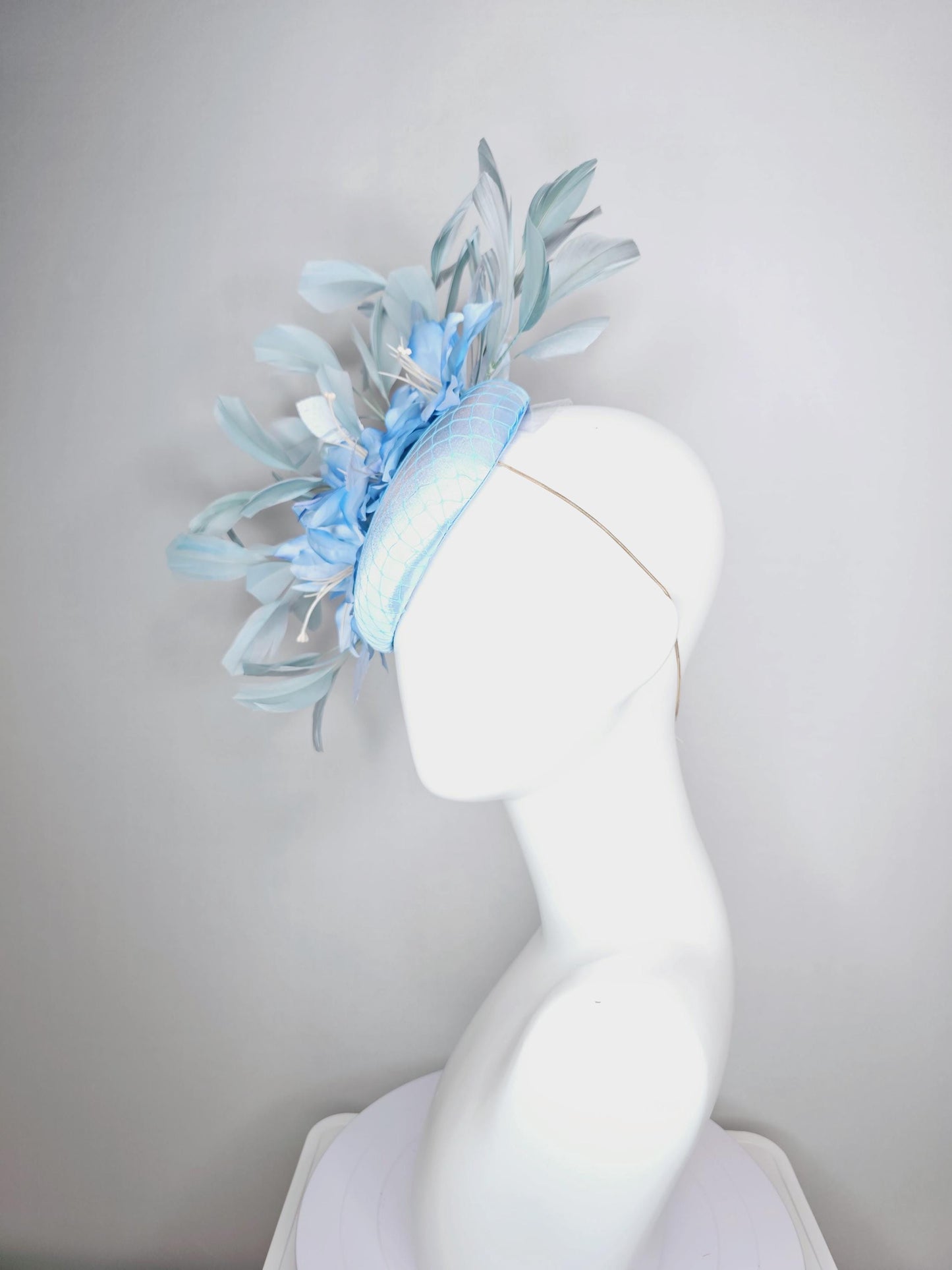 kentucky derby hat fascinator baby blue satin with netting light blue ombre satin flowers and leaves and light baby blue branching feathers