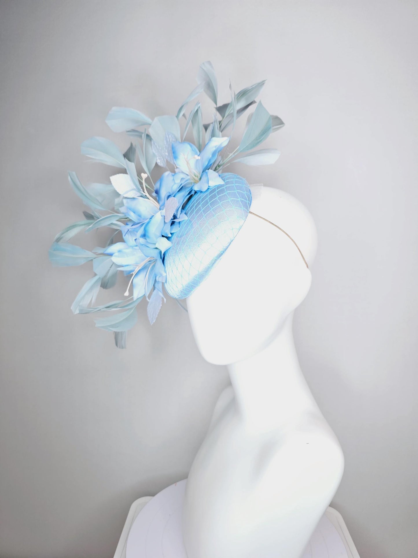 kentucky derby hat fascinator baby blue satin with netting light blue ombre satin flowers and leaves and light baby blue branching feathers