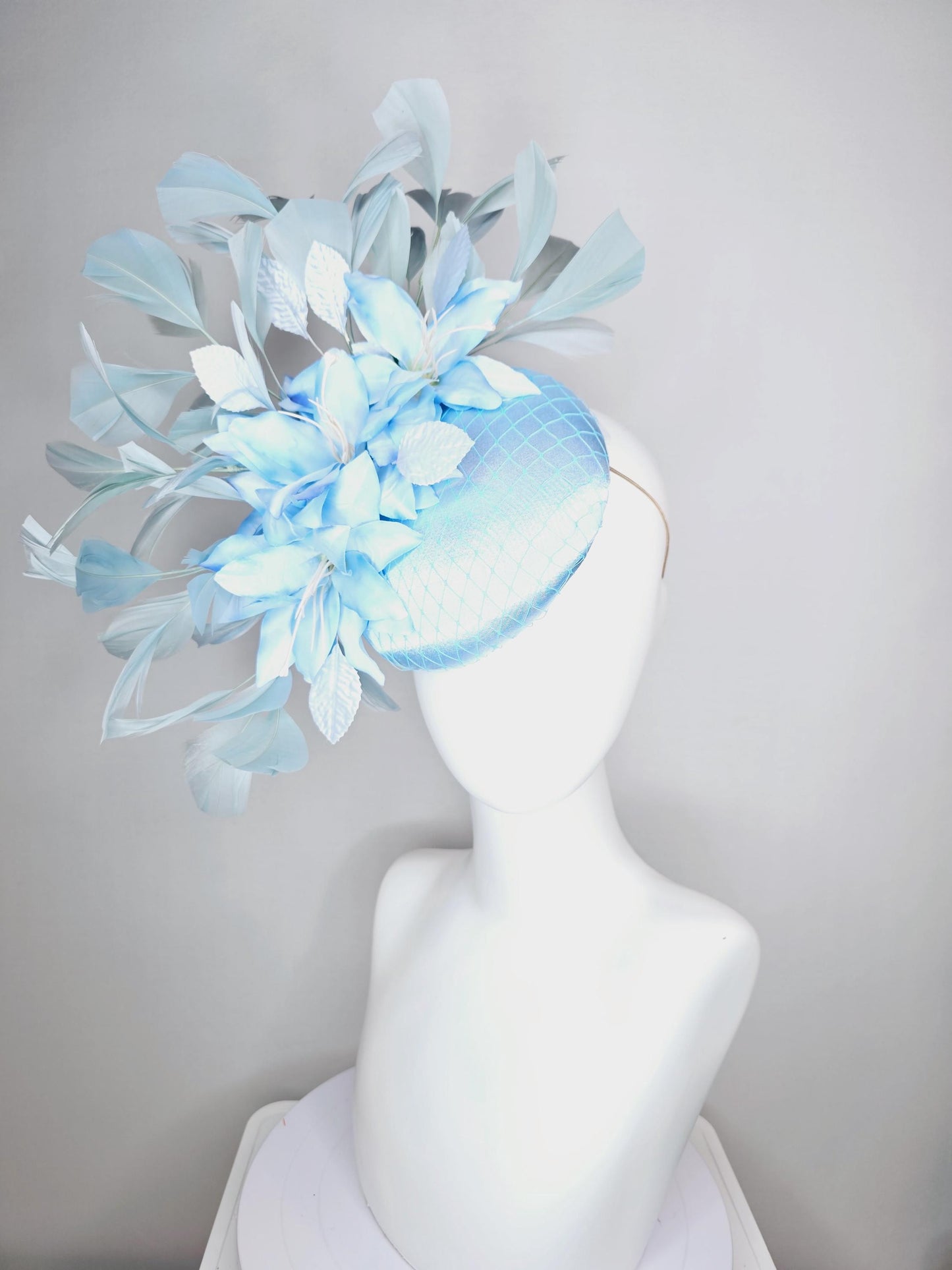 kentucky derby hat fascinator baby blue satin with netting light blue ombre satin flowers and leaves and light baby blue branching feathers