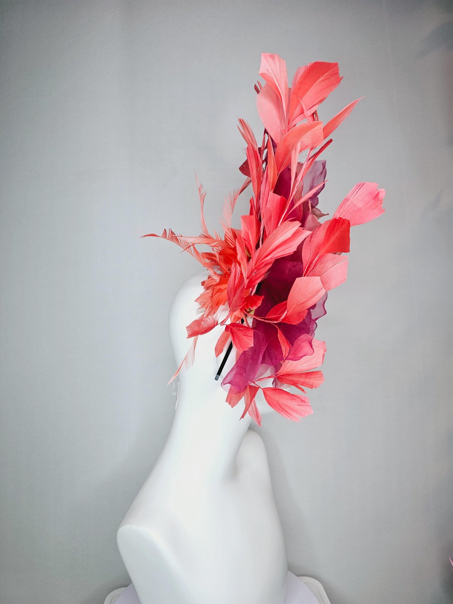 kentucky derby fascinator black headband with very large burgundy wine coral red organza flower and coral red branching feathers