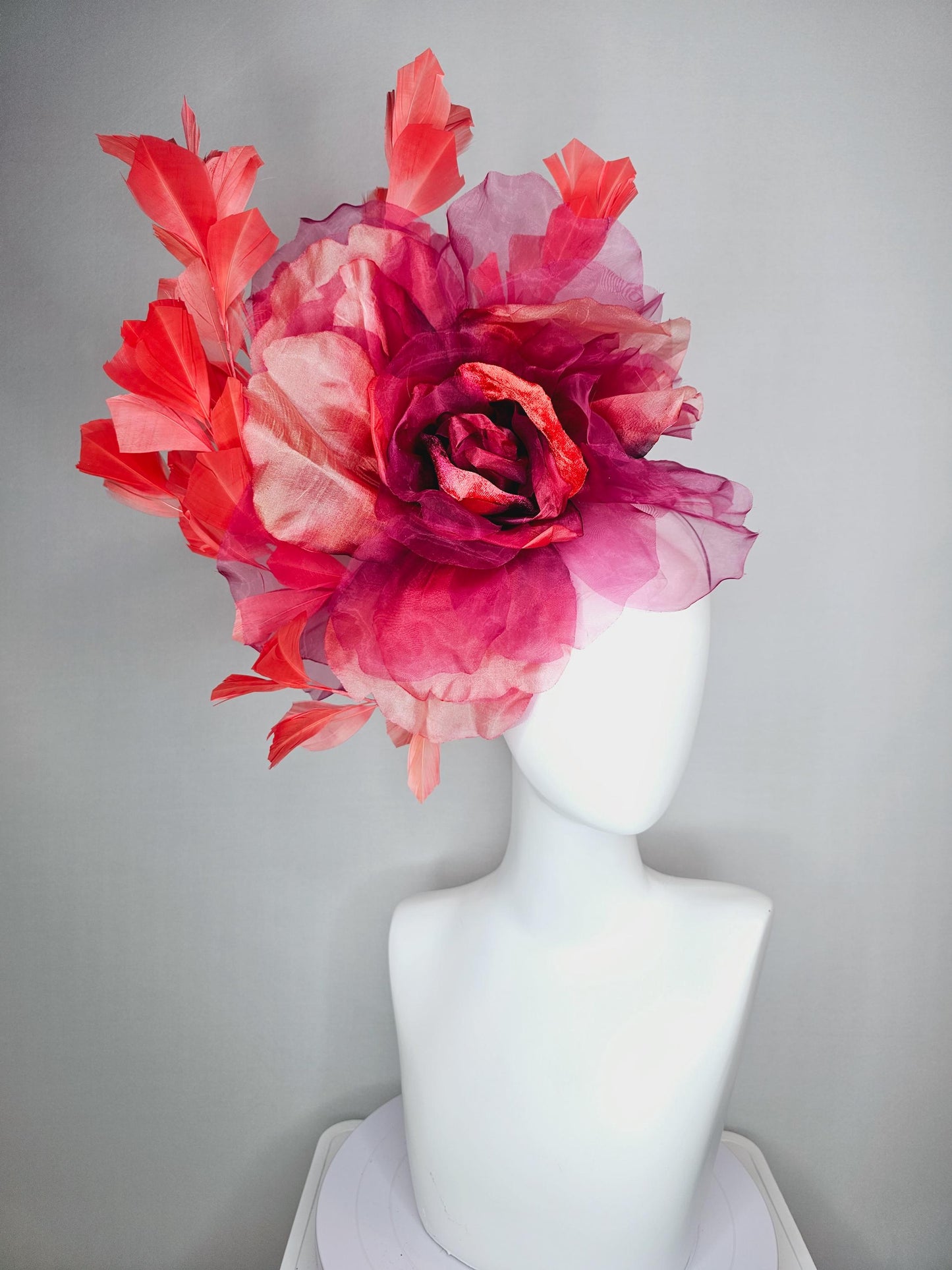 kentucky derby fascinator black headband with very large burgundy wine coral red organza flower and coral red branching feathers