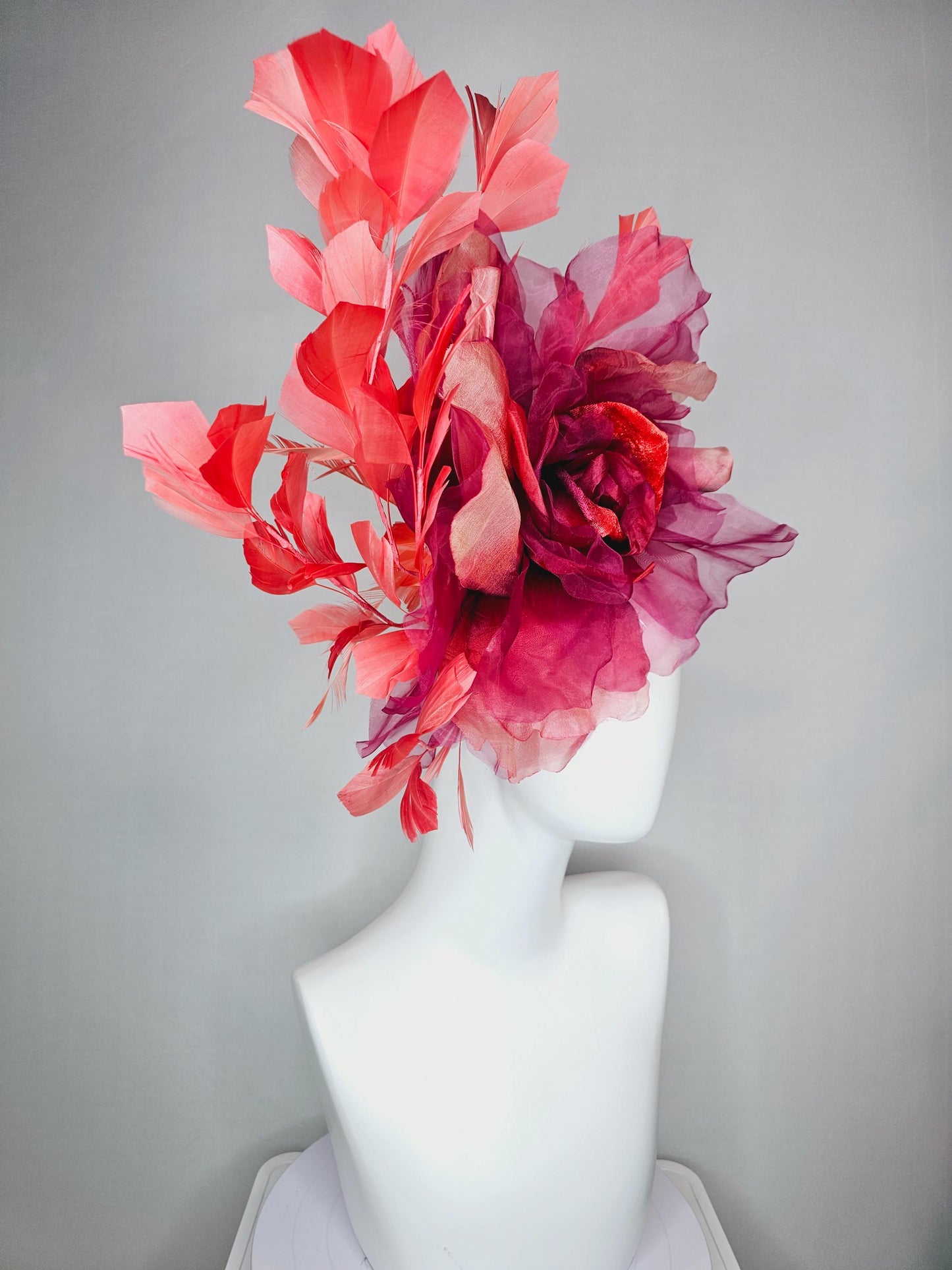 kentucky derby fascinator black headband with very large burgundy wine coral red organza flower and coral red branching feathers