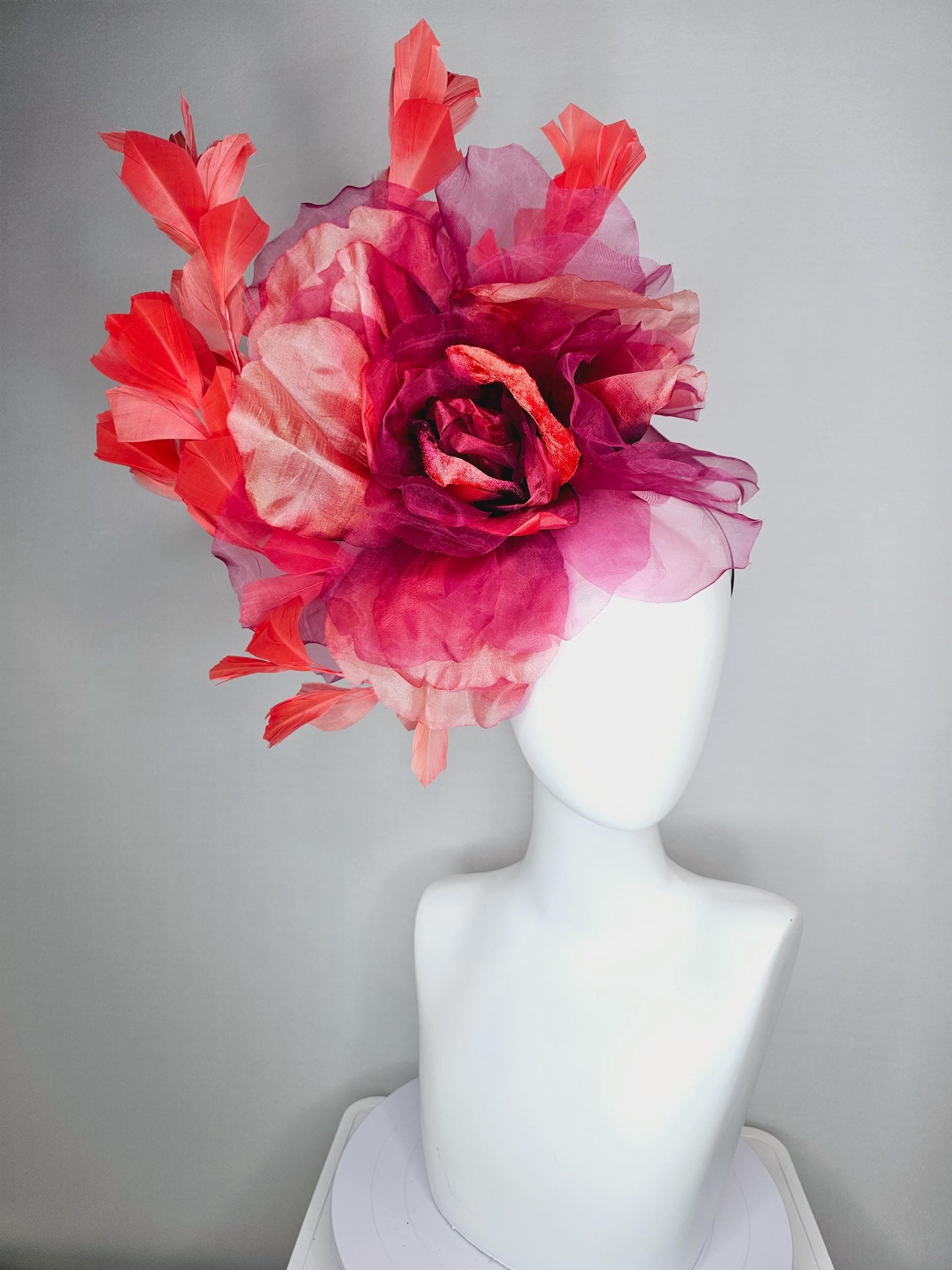 kentucky derby fascinator black headband with very large burgundy wine coral red organza flower and coral red branching feathers