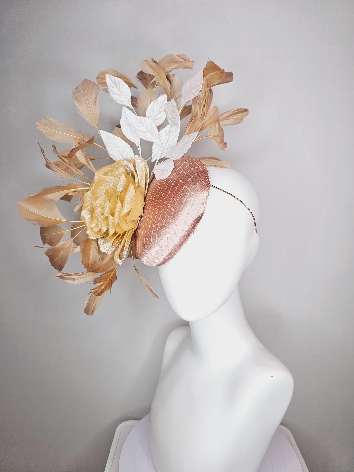 kentucky derby hat fascinator champagne pink satin with netting gold satin rose flower white leaves neutral tan beige branching feathers