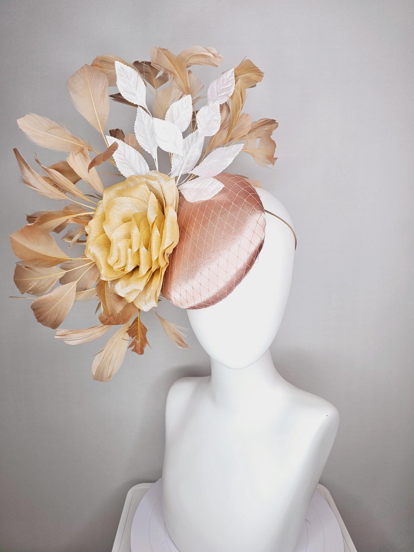 kentucky derby hat fascinator champagne pink satin with netting gold satin rose flower white leaves neutral tan beige branching feathers