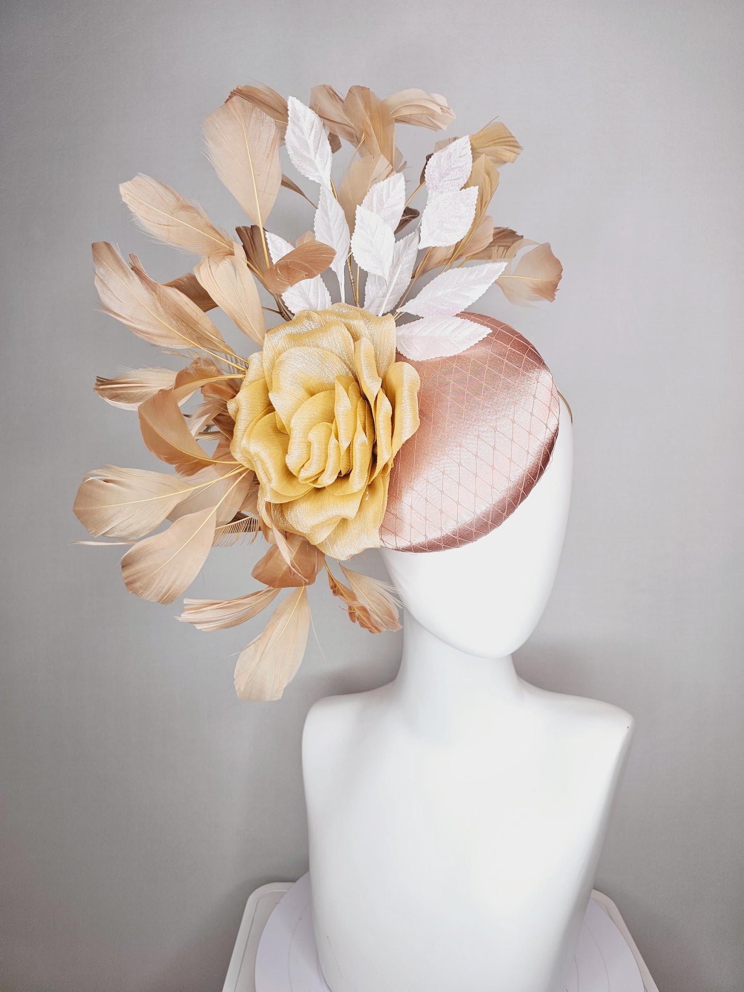 kentucky derby hat fascinator champagne pink satin with netting gold satin rose flower white leaves neutral tan beige branching feathers
