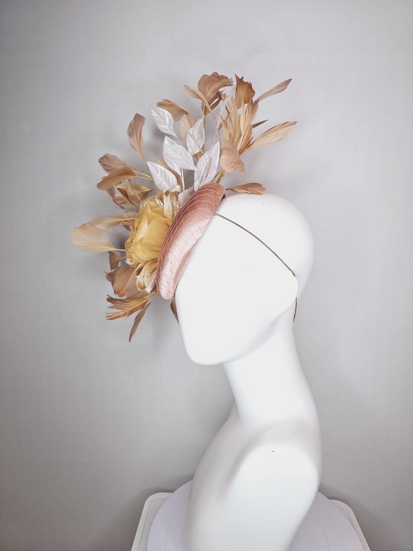 kentucky derby hat fascinator champagne pink satin with netting gold satin rose flower white leaves neutral tan beige branching feathers