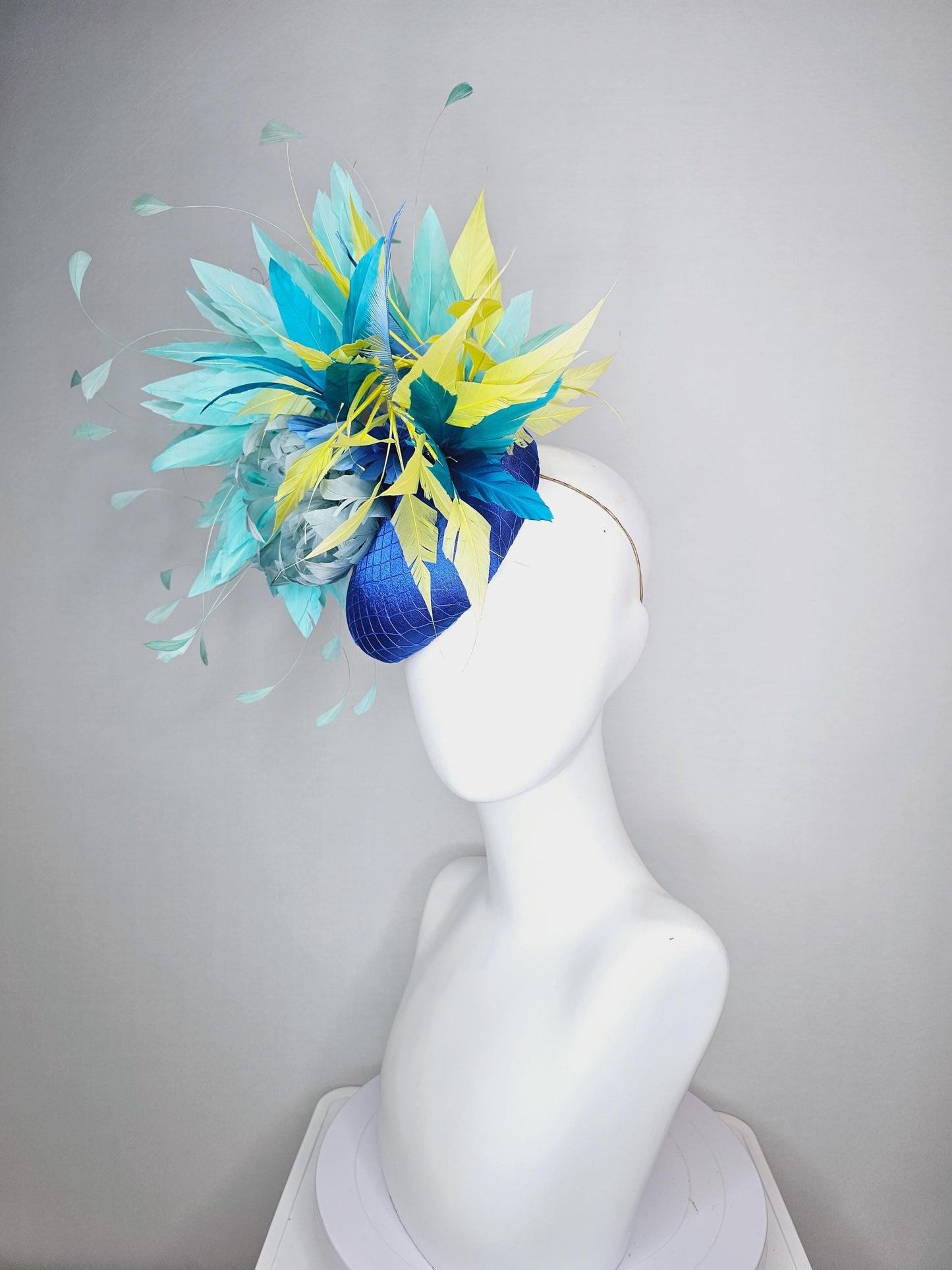 kentucky derby hat fascinator royal blue satin with netting light blue fluffy feather flower turquoise teal and yellow branching feathers