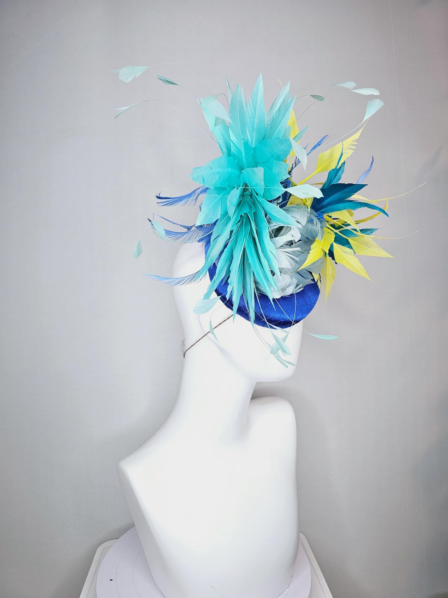 kentucky derby hat fascinator royal blue satin with netting light blue fluffy feather flower turquoise teal and yellow branching feathers