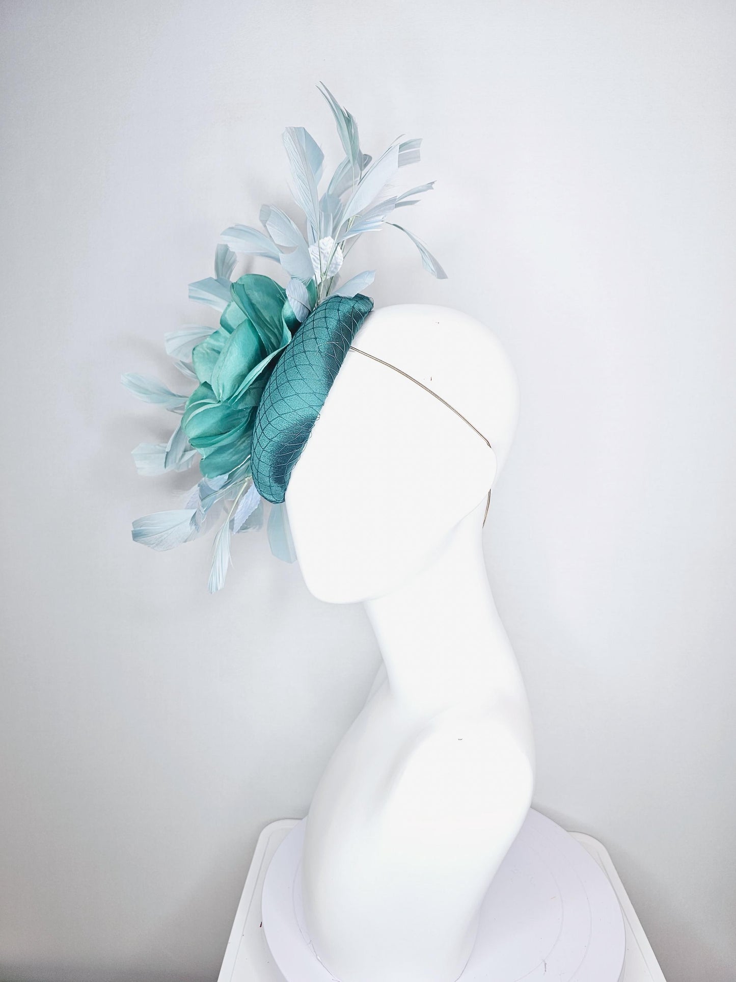 kentucky derby fascinator green satin with netting with large aqua blue silk flower with beaded core white velvet leaves light blue feathers