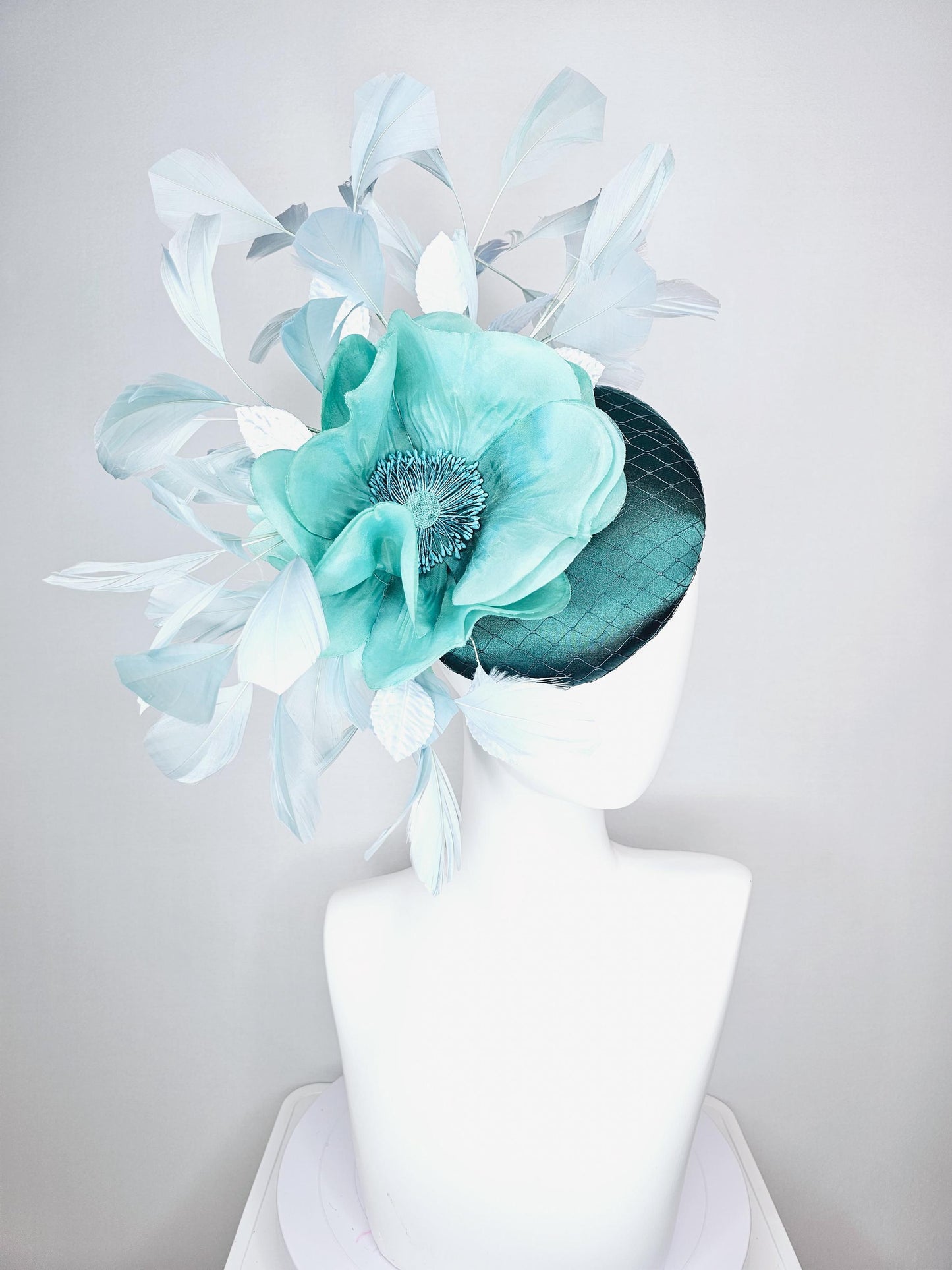 kentucky derby fascinator green satin with netting with large aqua blue silk flower with beaded core white velvet leaves light blue feathers