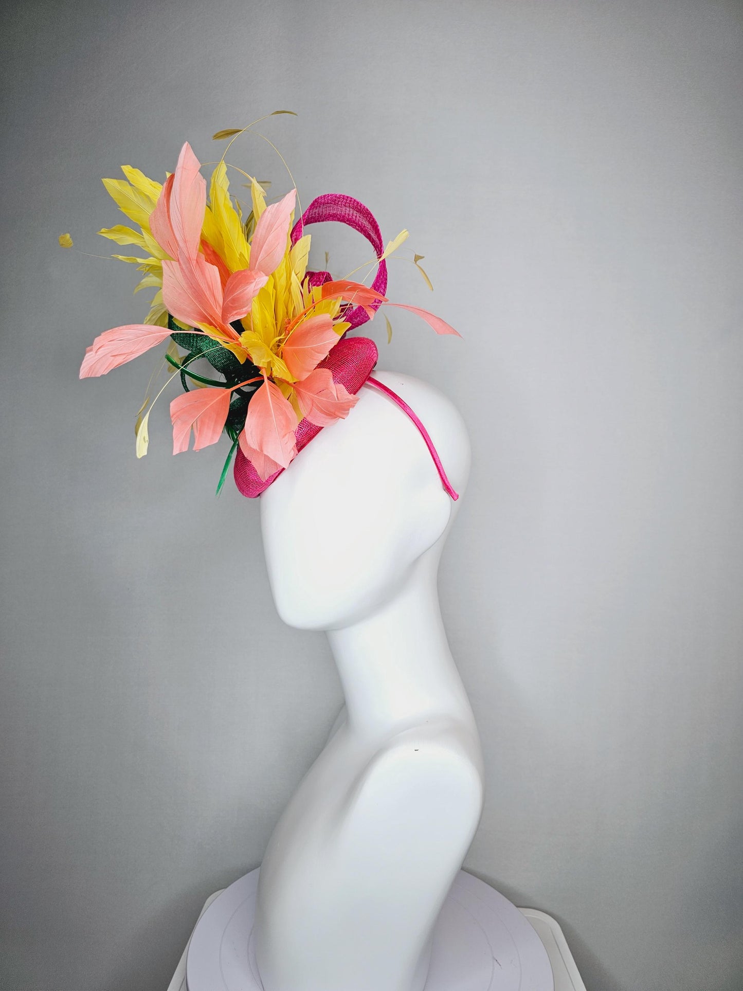 kentucky derby hat fascinator hot pink sinamay with dark green sinamay curls and yellow and peach coral branching feathers