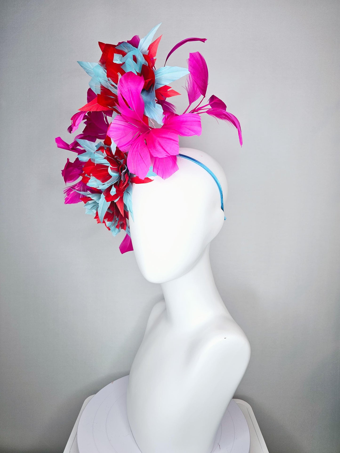 kentucky derby hat fascinator with large scarlet red and baby blue feather flowers and bright pink branching feathers