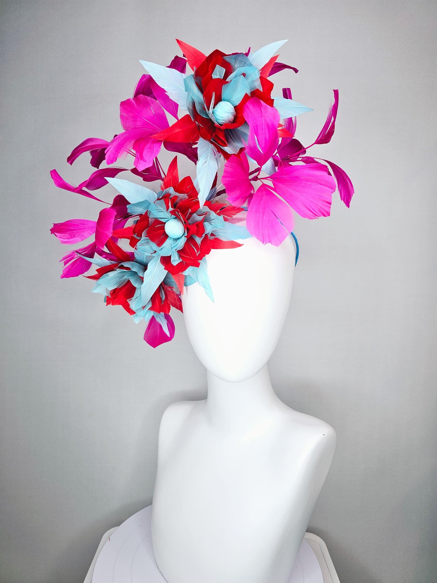 kentucky derby hat fascinator with large scarlet red and baby blue feather flowers and bright pink branching feathers
