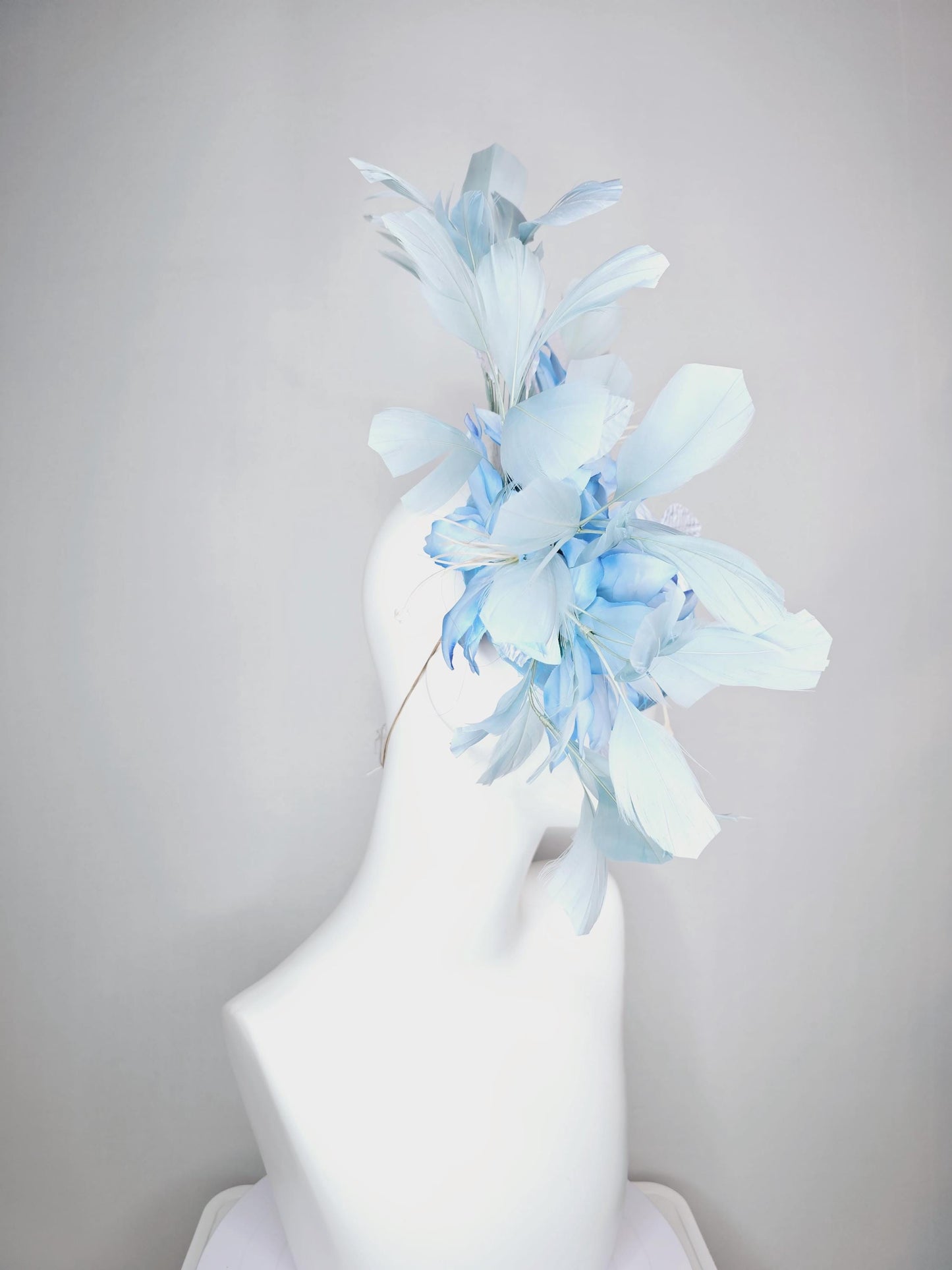 kentucky derby hat fascinator baby blue satin with netting light blue ombre satin flowers and leaves and light baby blue branching feathers
