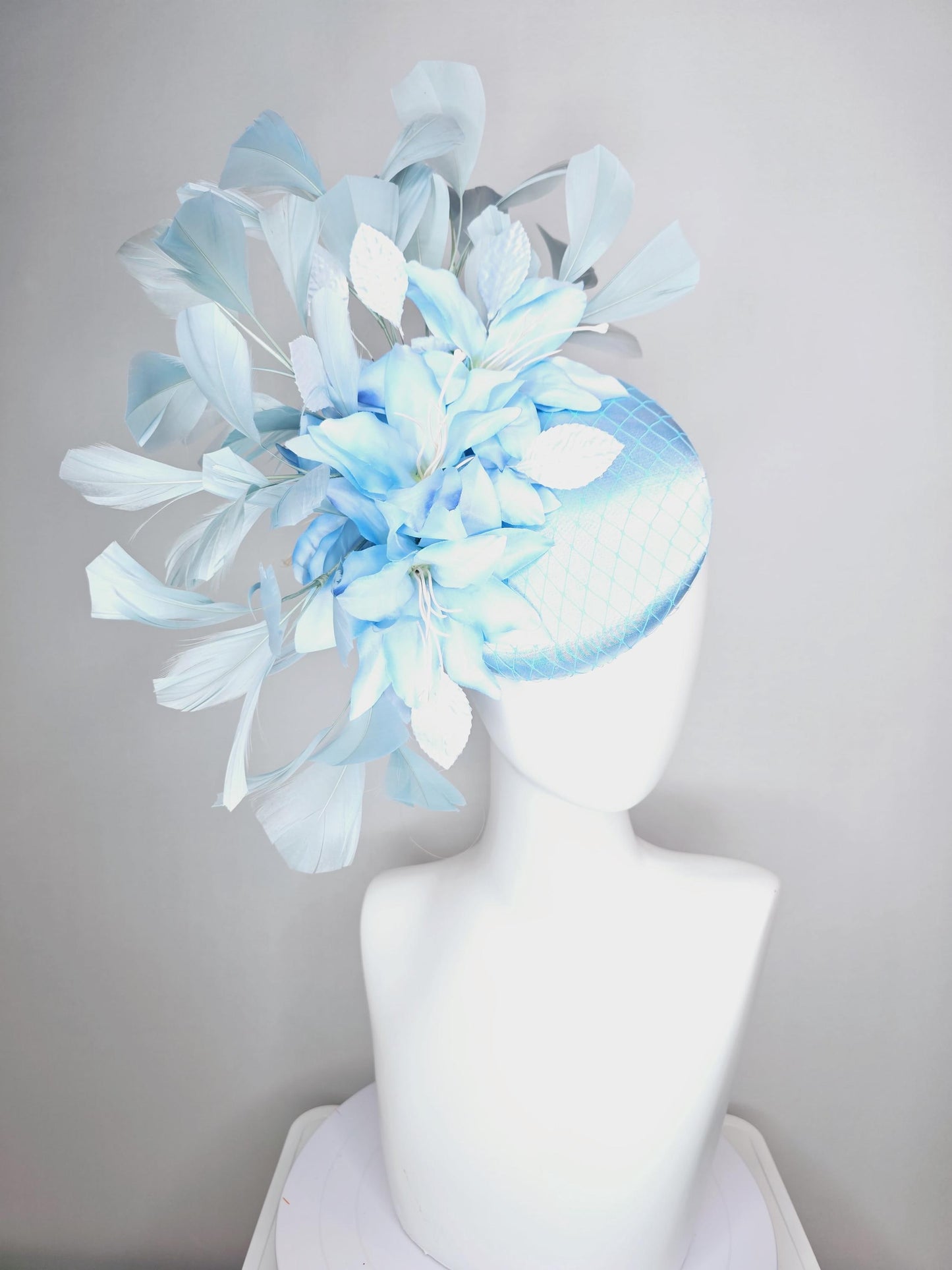 kentucky derby hat fascinator baby blue satin with netting light blue ombre satin flowers and leaves and light baby blue branching feathers