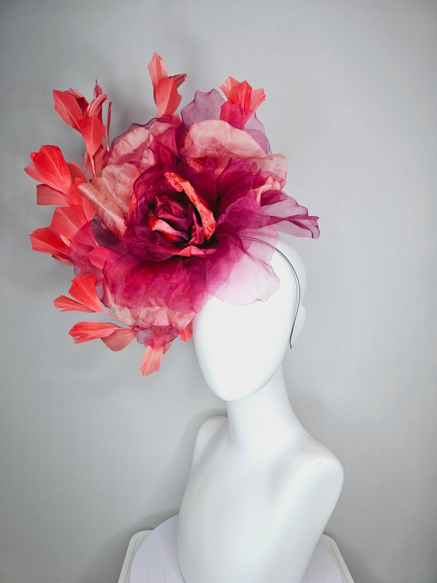 kentucky derby fascinator black headband with very large burgundy wine coral red organza flower and coral red branching feathers