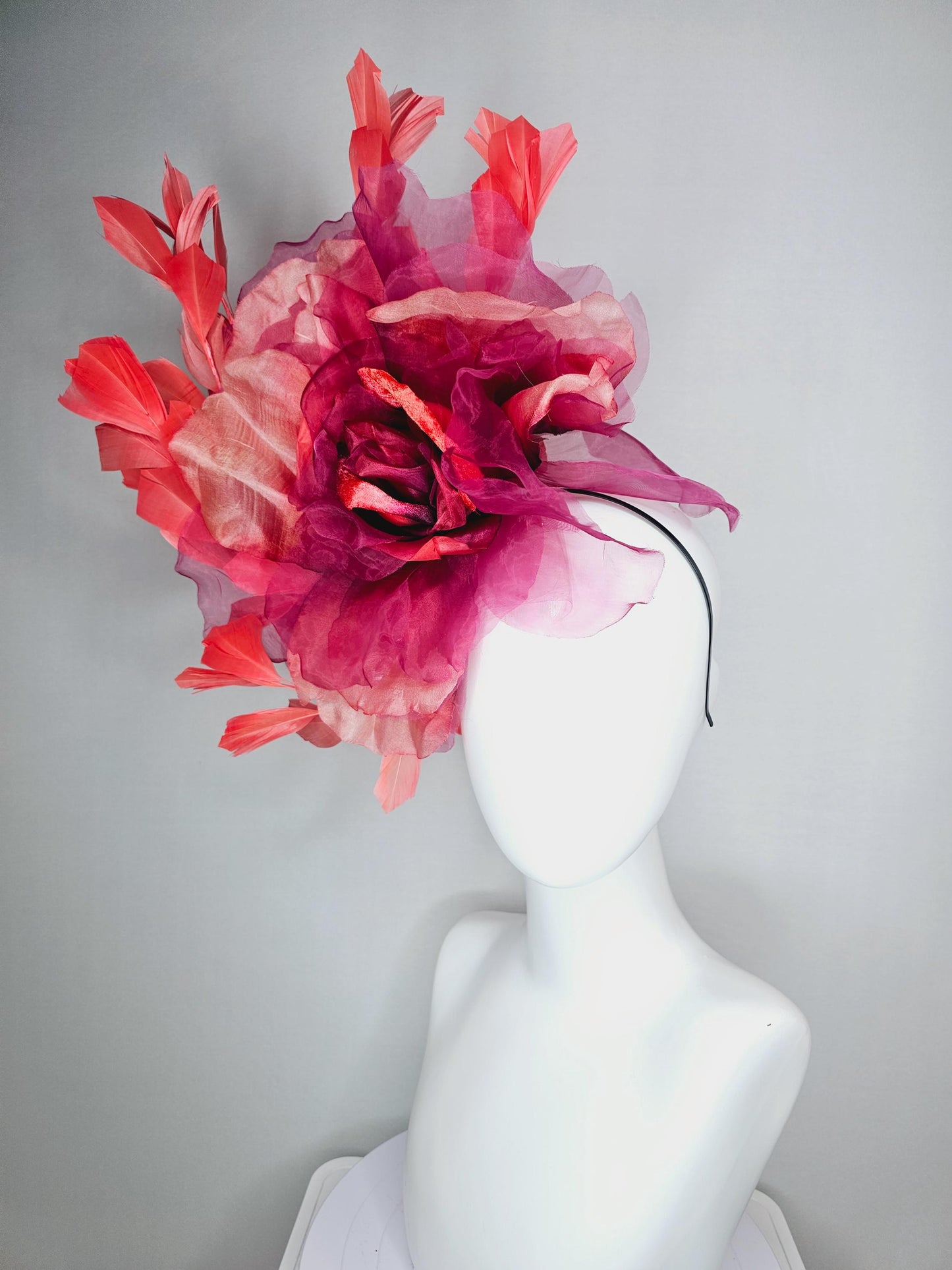 kentucky derby fascinator black headband with very large burgundy wine coral red organza flower and coral red branching feathers