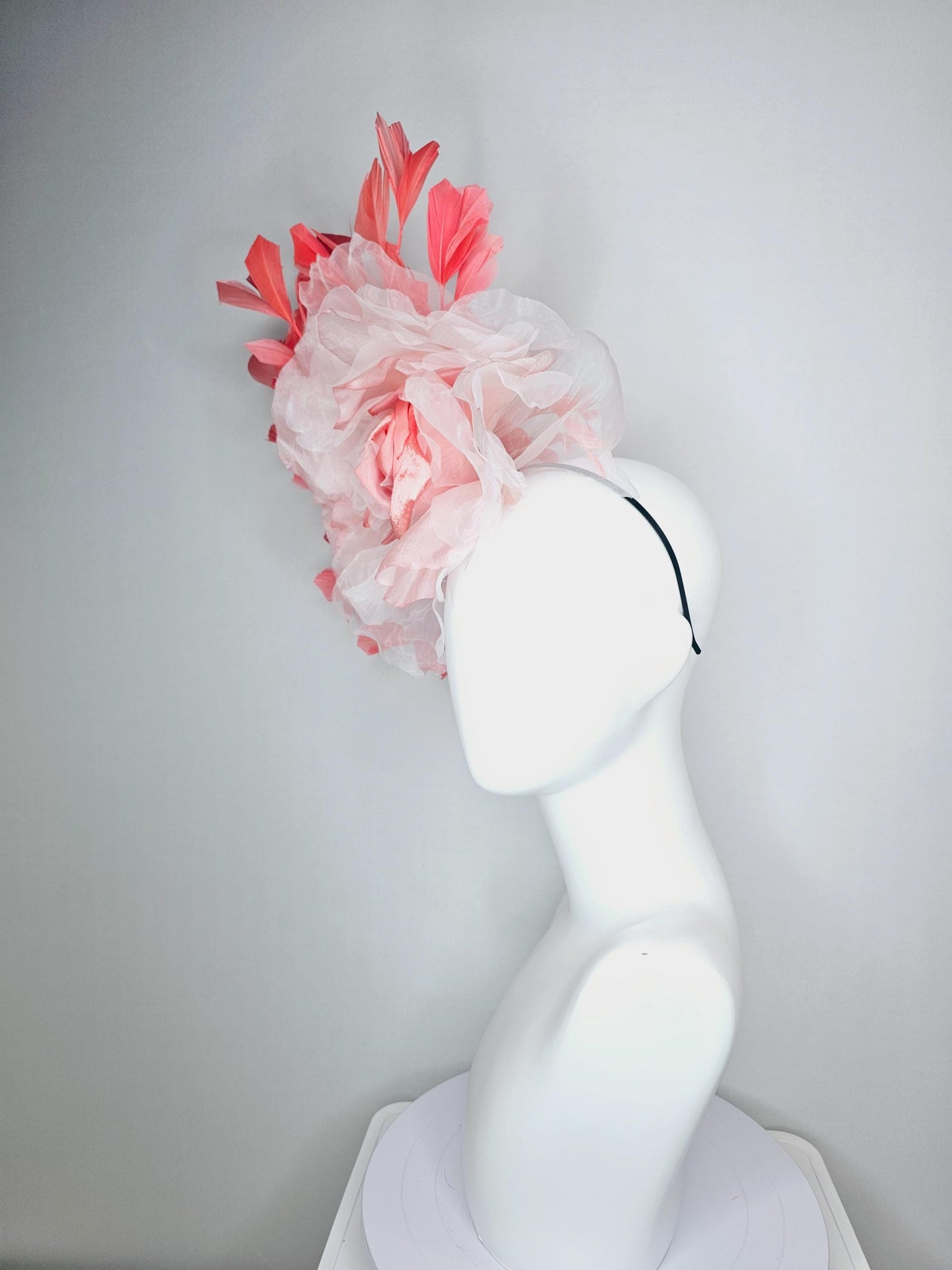 kentucky derby fascinator black headband with very large light pink organza silk flower and coral red branching feathers