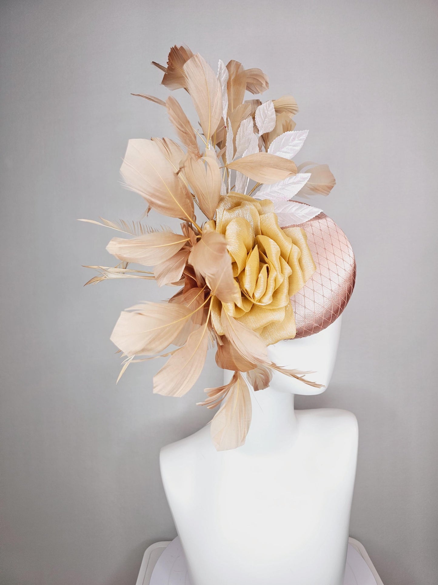 kentucky derby hat fascinator champagne pink satin with netting gold satin rose flower white leaves neutral tan beige branching feathers