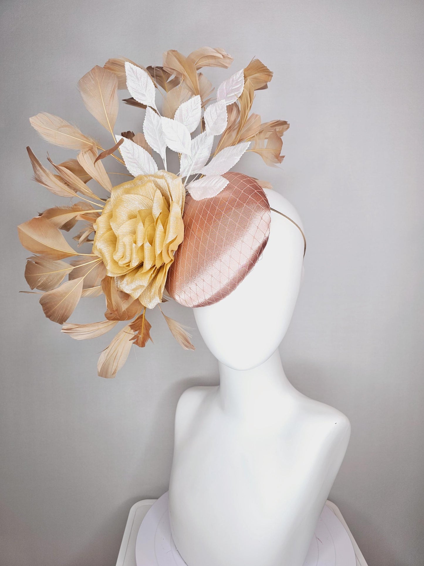 kentucky derby hat fascinator champagne pink satin with netting gold satin rose flower white leaves neutral tan beige branching feathers