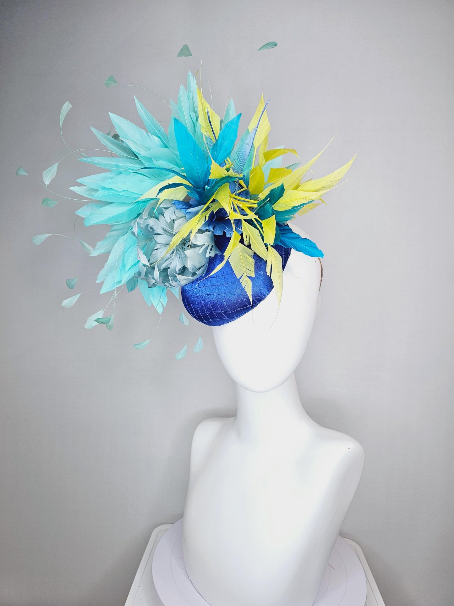 kentucky derby hat fascinator royal blue satin with netting light blue fluffy feather flower turquoise teal and yellow branching feathers
