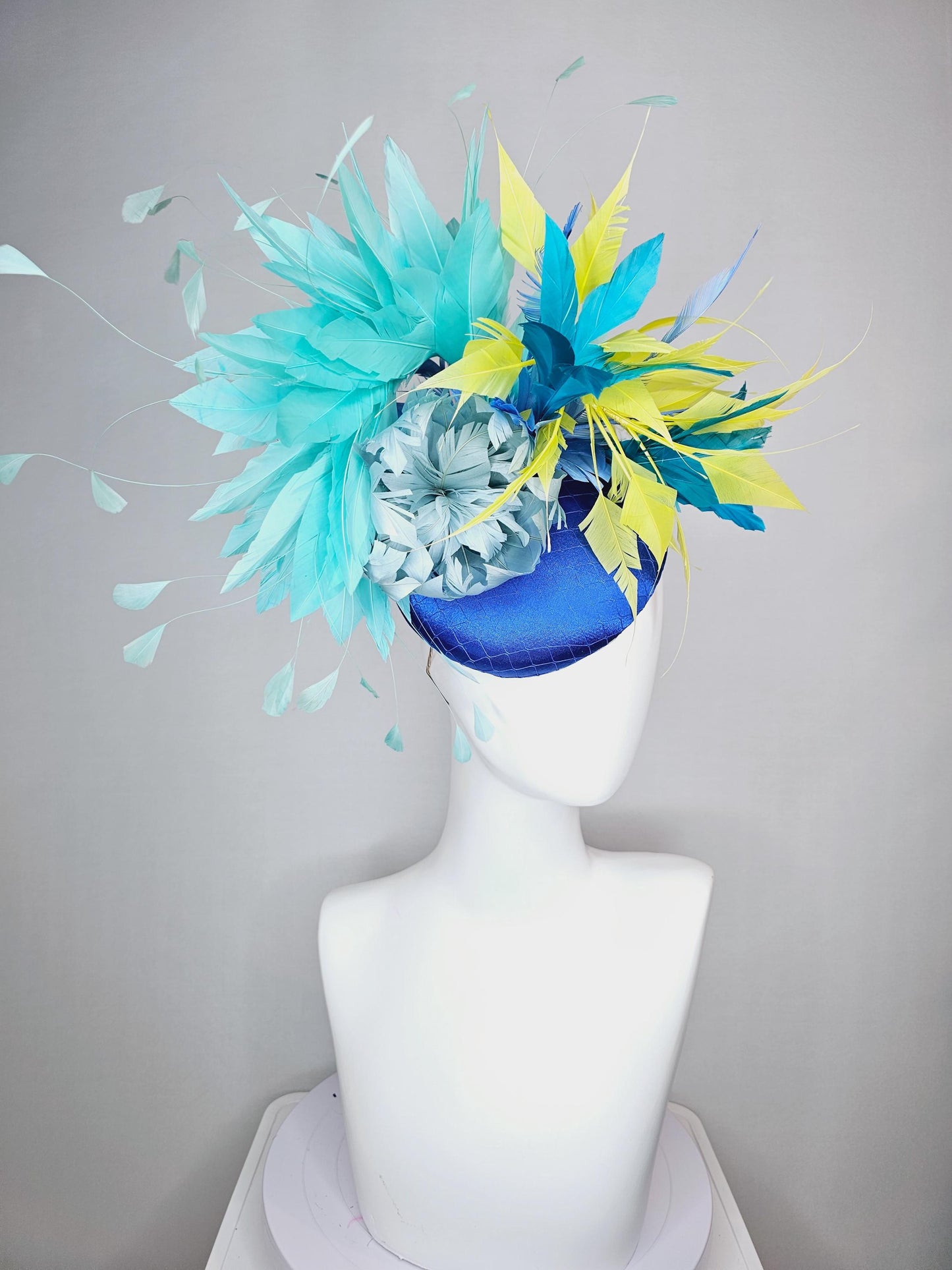 kentucky derby hat fascinator royal blue satin with netting light blue fluffy feather flower turquoise teal and yellow branching feathers