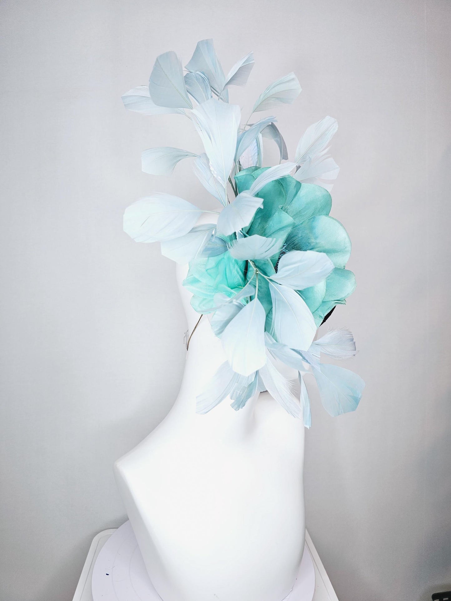 kentucky derby fascinator green satin with netting with large aqua blue silk flower with beaded core white velvet leaves light blue feathers