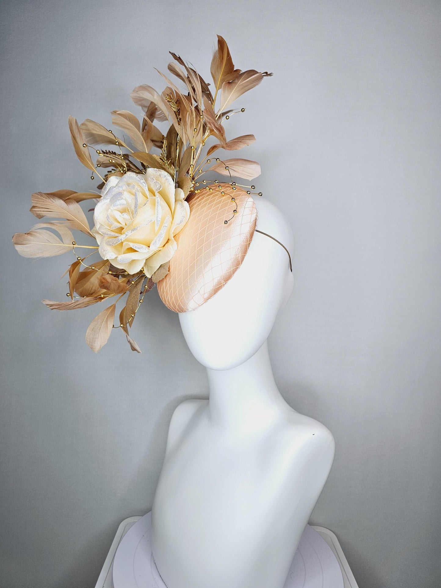 kentucky derby hat fascinator champagne pink satin with netting neutral cream satin rose flower gold leaves tan beige branching feathers