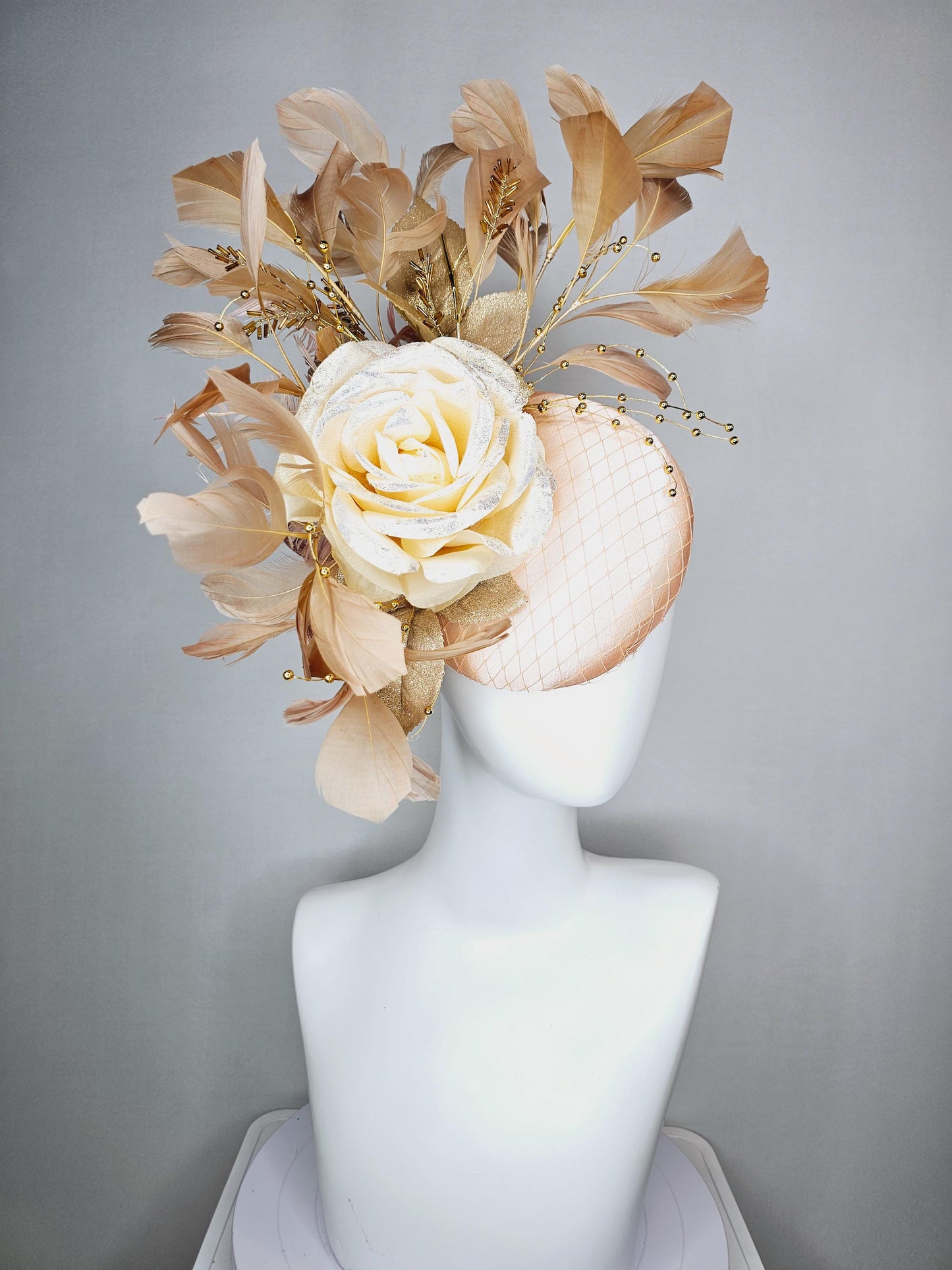 kentucky derby hat fascinator champagne pink satin with netting neutral cream satin rose flower gold leaves tan beige branching feathers