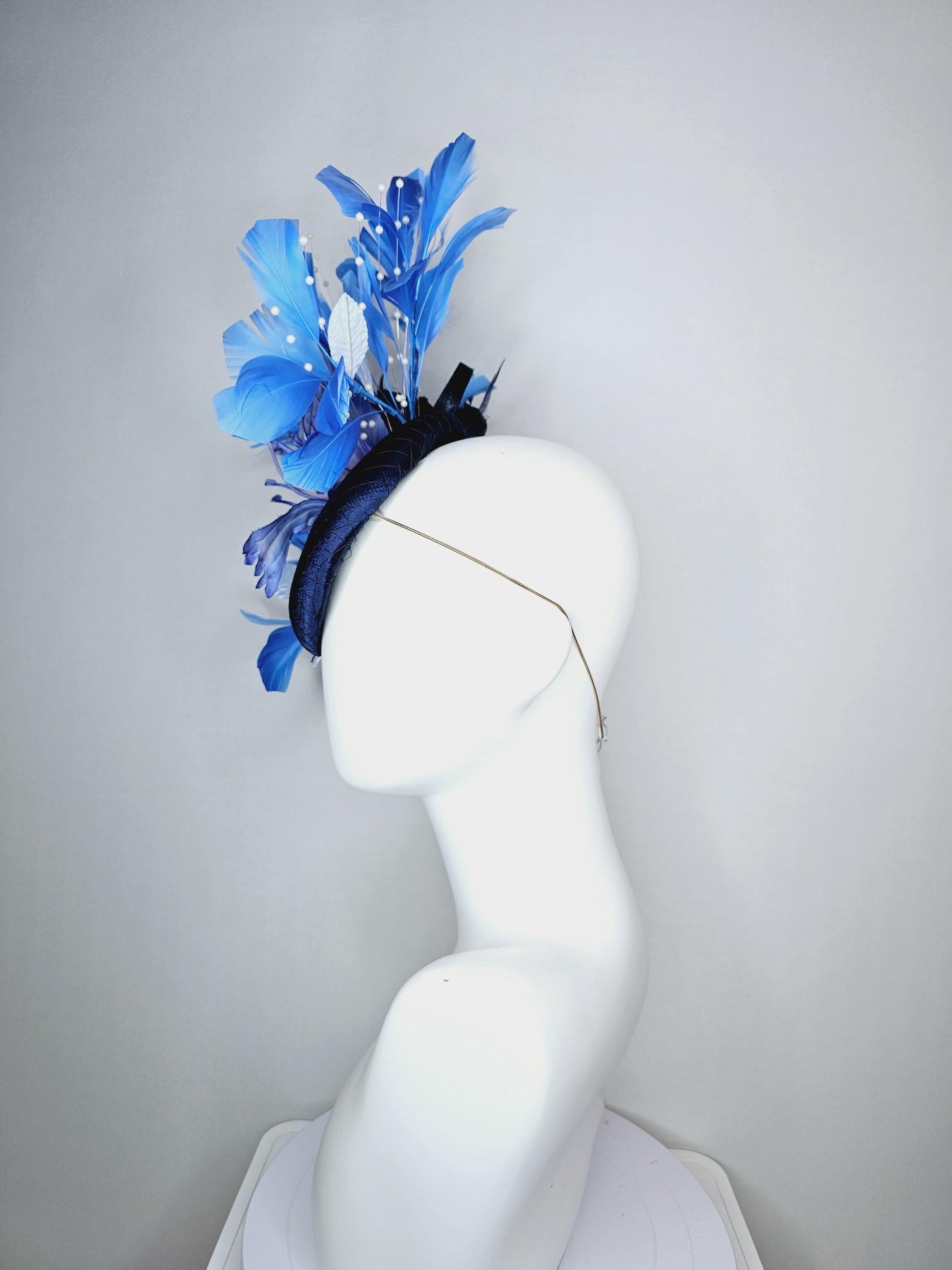 kentucky derby hat fascinator navy blue satin with netting large ombre blue satin flower white leaves navy blue sky blue branching feathers