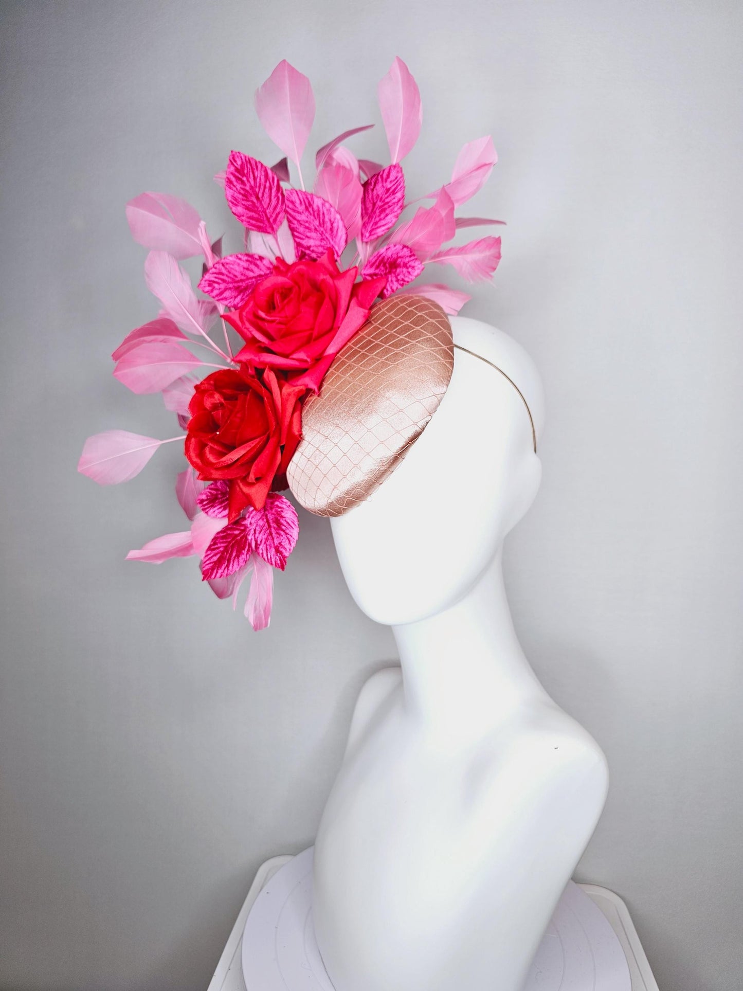 kentucky derby hat fascinator champagne pink satin with netting red satin rose flowers pink leaves and baby blush pink branching feathers
