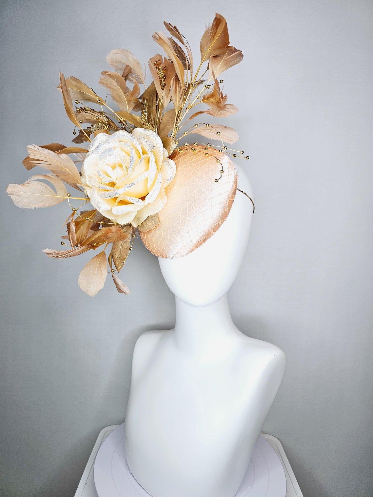 kentucky derby hat fascinator champagne pink satin with netting neutral cream satin rose flower gold leaves tan beige branching feathers