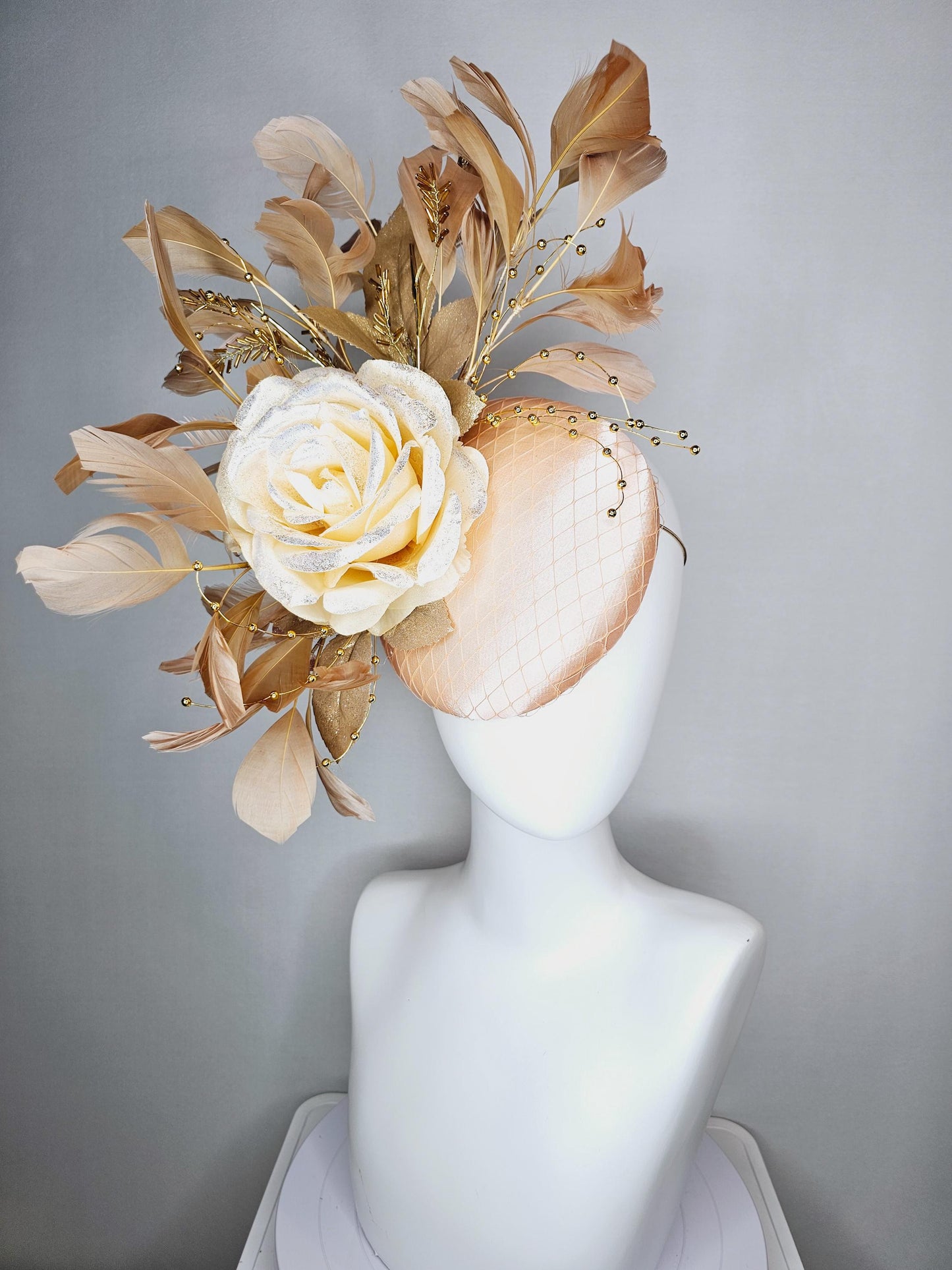 kentucky derby hat fascinator champagne pink satin with netting neutral cream satin rose flower gold leaves tan beige branching feathers