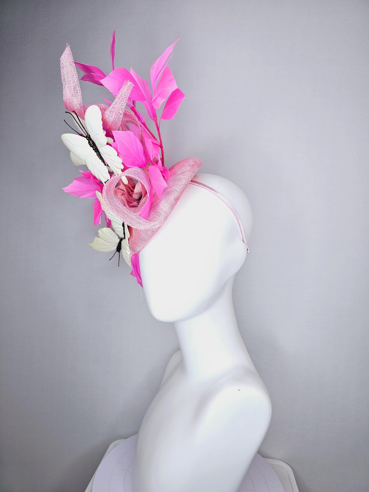 kentucky derby hat fascinator baby pink sinamay with tall curls baby pink satin flower white large butterflies and pink branching feathers