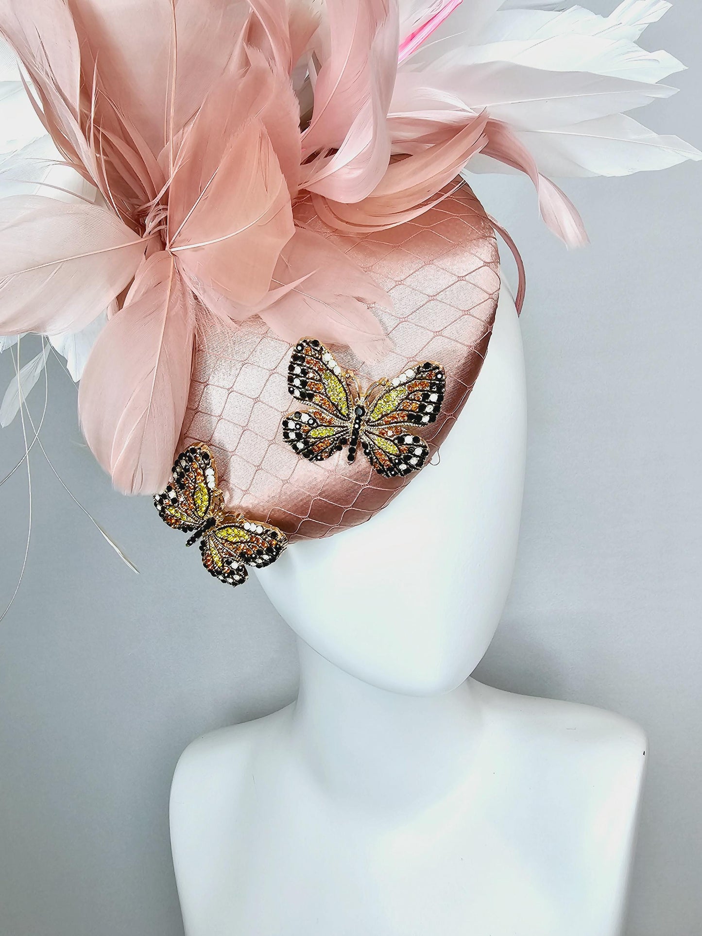 kentucky derby hat fascinator champagne pink satin with netting and colorful crystal jewels butterflies dusty pink white branching feathers