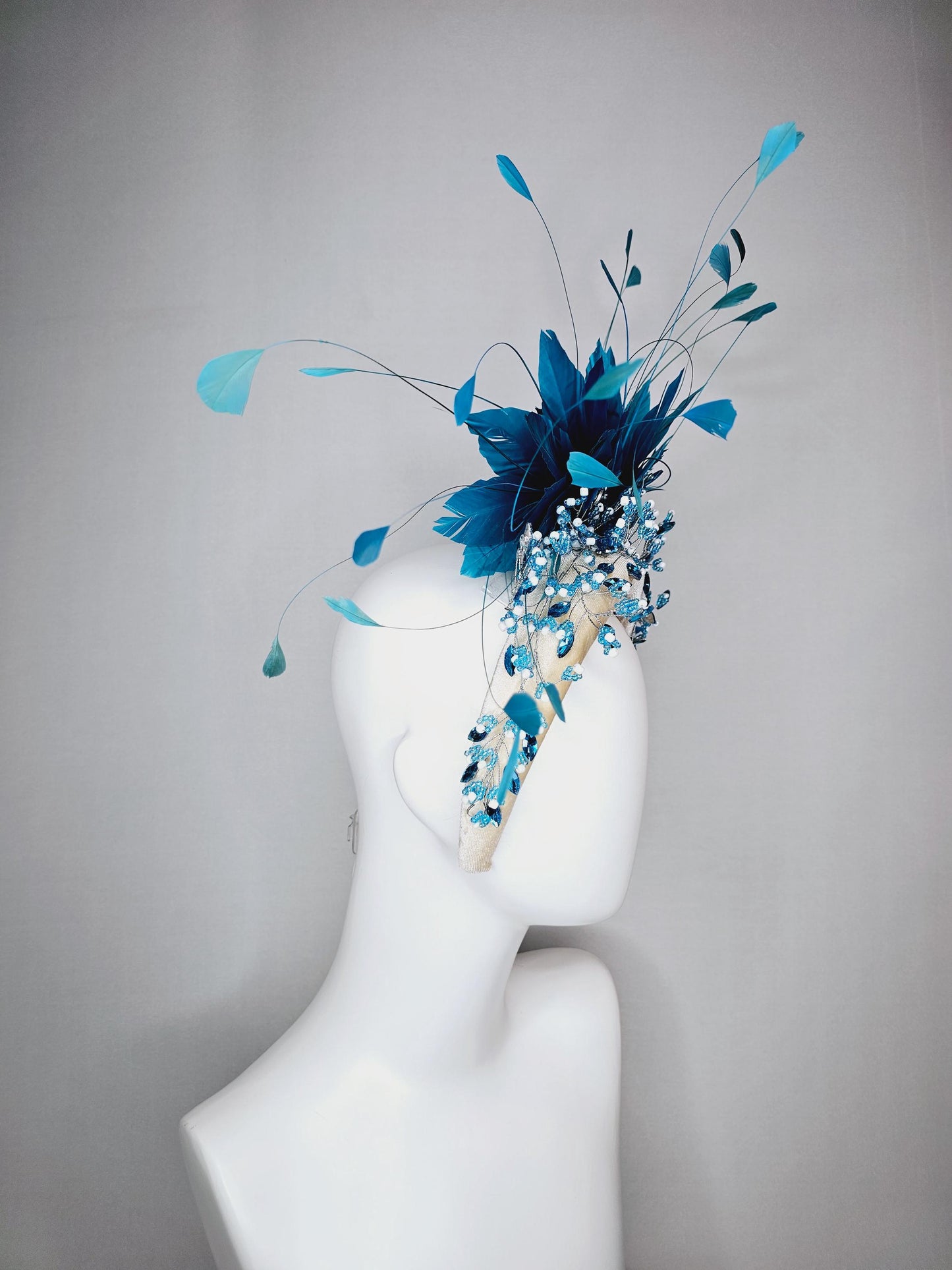 kentucky derby hat fascinator neutral cream velvet headband with blue crystal stems and bright blue branching feathers