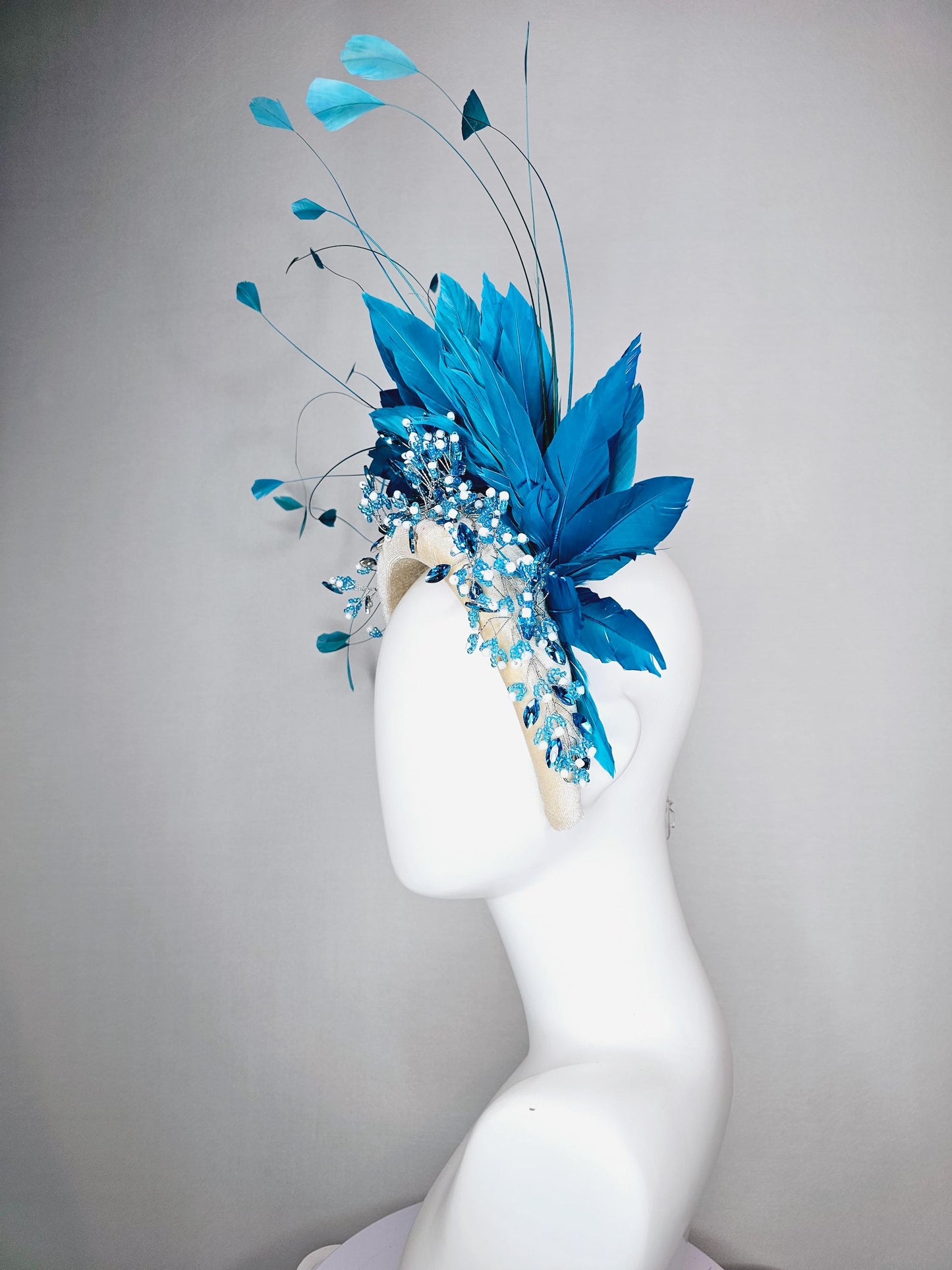 kentucky derby hat fascinator neutral cream velvet headband with blue crystal stems and bright blue branching feathers