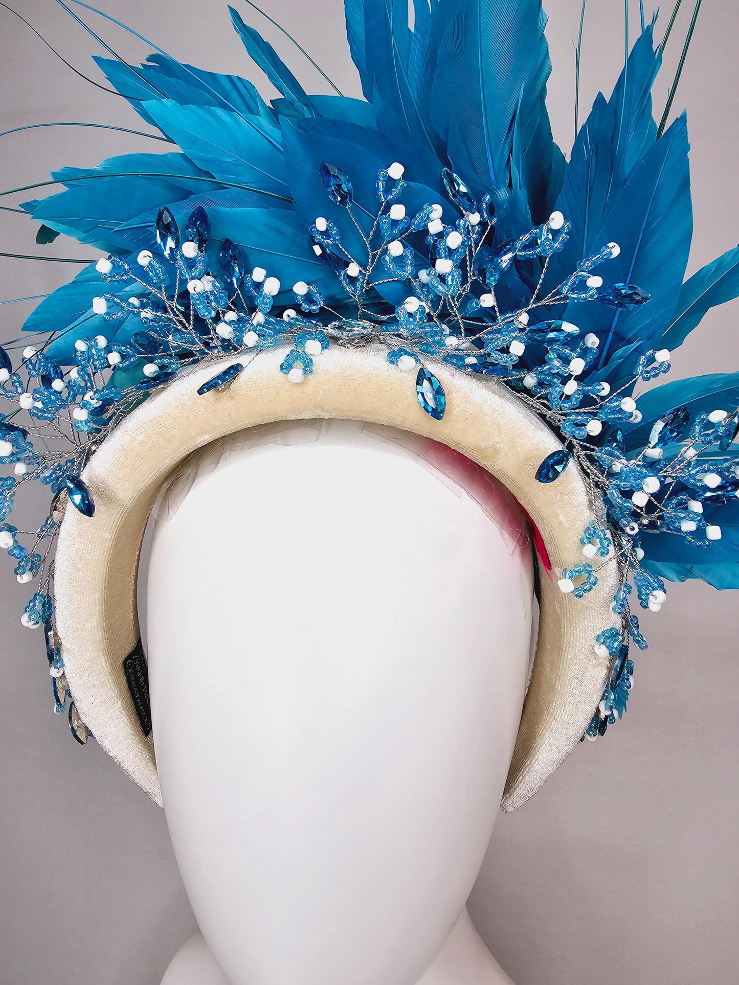 kentucky derby hat fascinator neutral cream velvet headband with blue crystal stems and bright blue branching feathers
