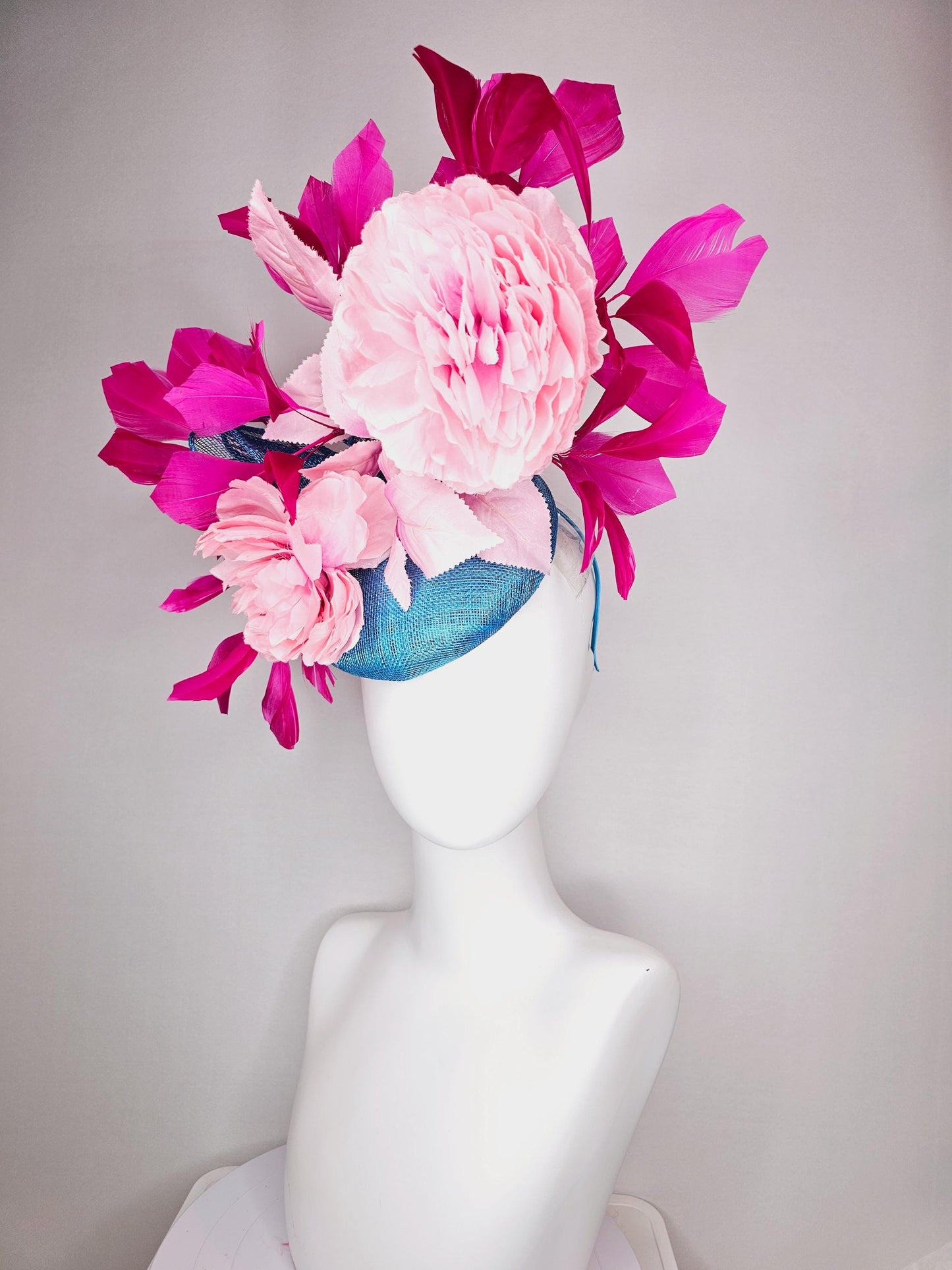 kentucky derby hat fascinator blue sinamay with bow and light pink peony satin flowers light pink leaves hot bright pink branching feathers