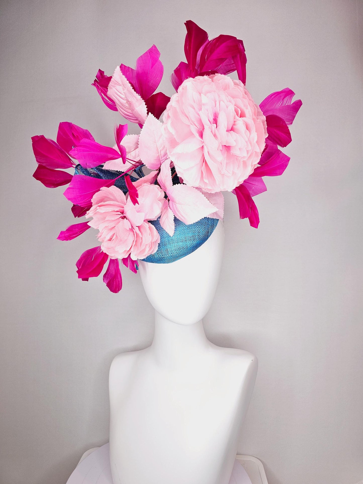 kentucky derby hat fascinator blue sinamay with bow and light pink peony satin flowers light pink leaves hot bright pink branching feathers