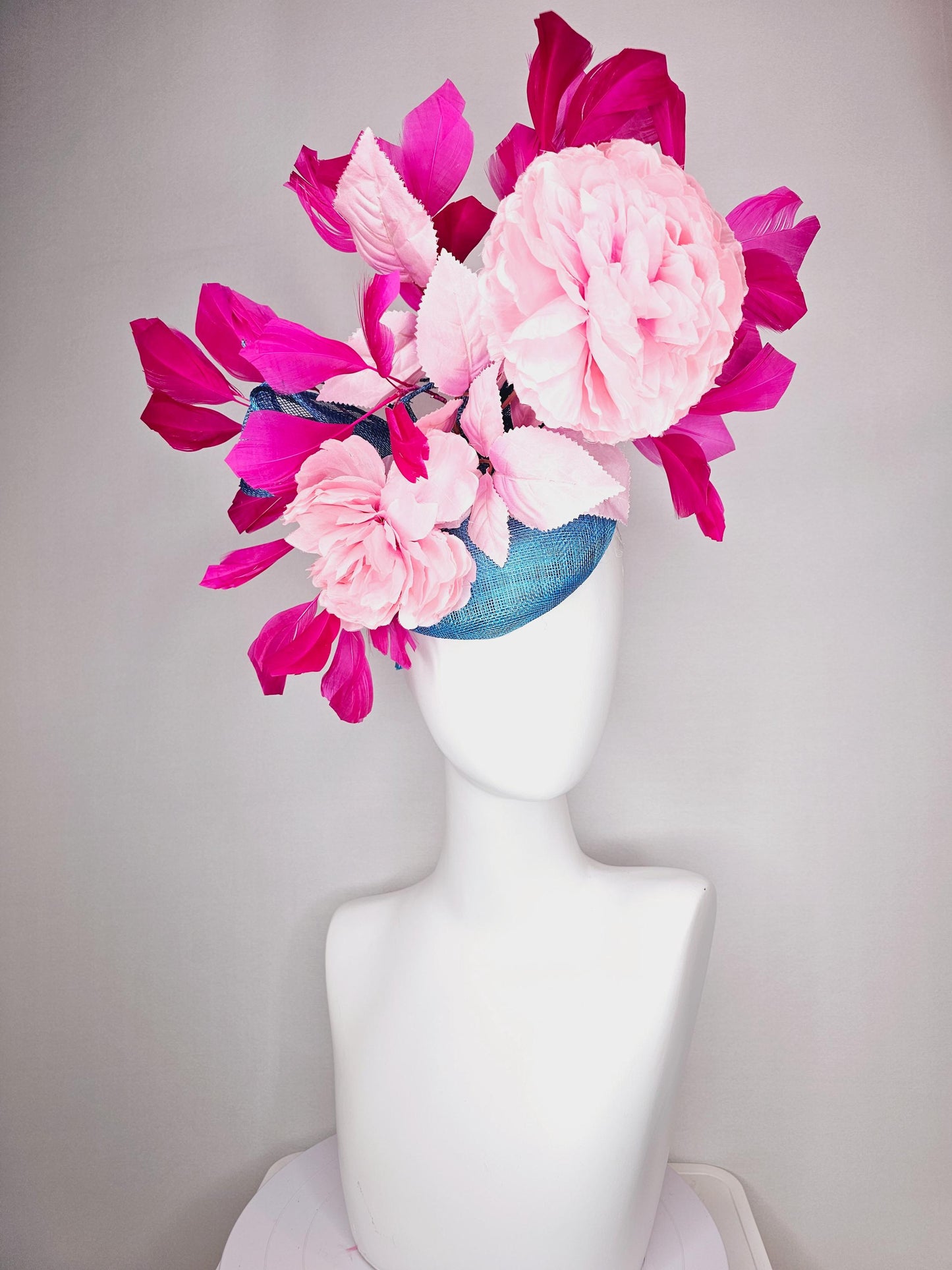 kentucky derby hat fascinator blue sinamay with bow and light pink peony satin flowers light pink leaves hot bright pink branching feathers