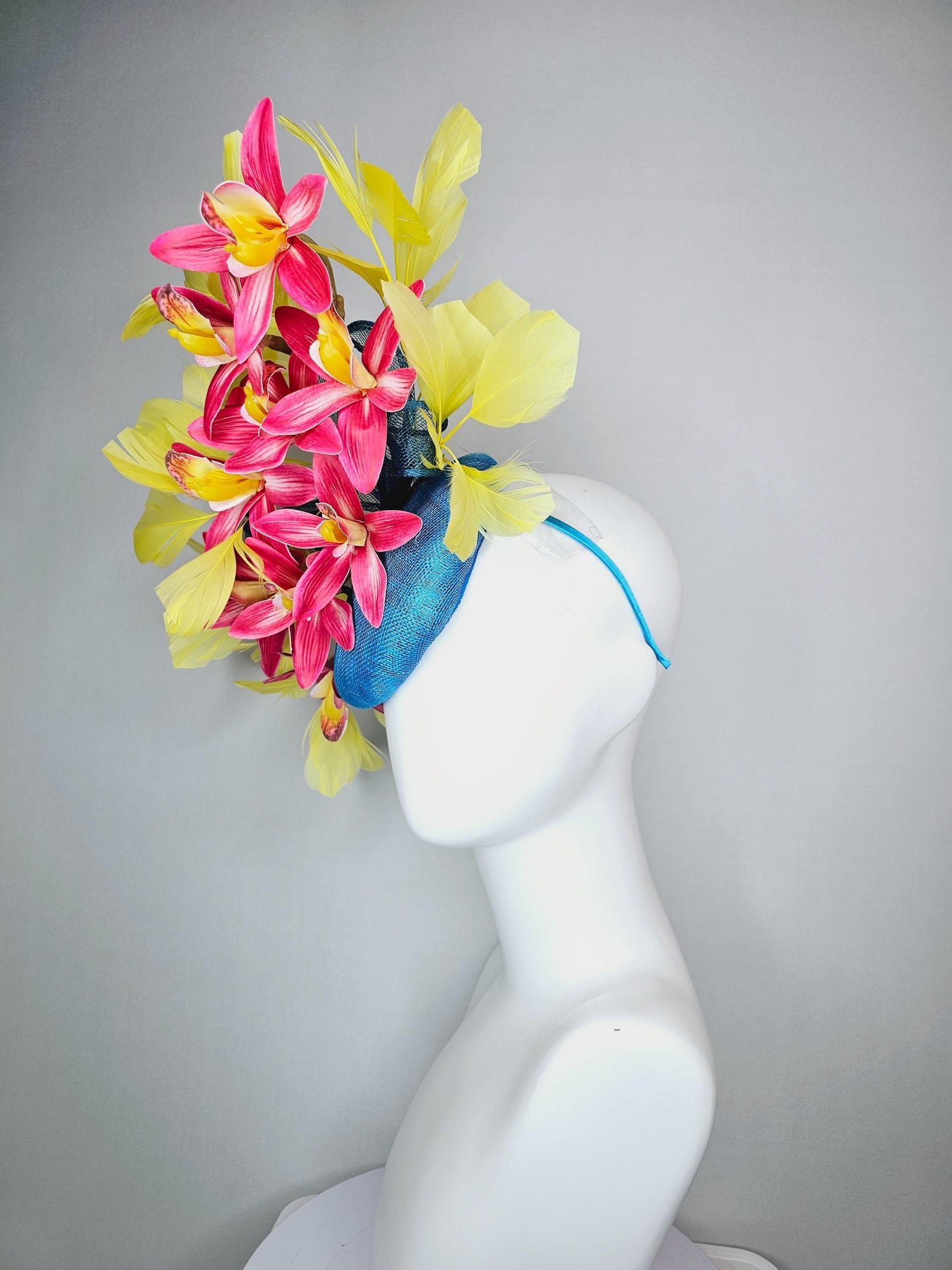kentucky derby hat fascinator turquoise blue sinamay with bow and raspberry red satin orchid flowers with yellow branching feathers