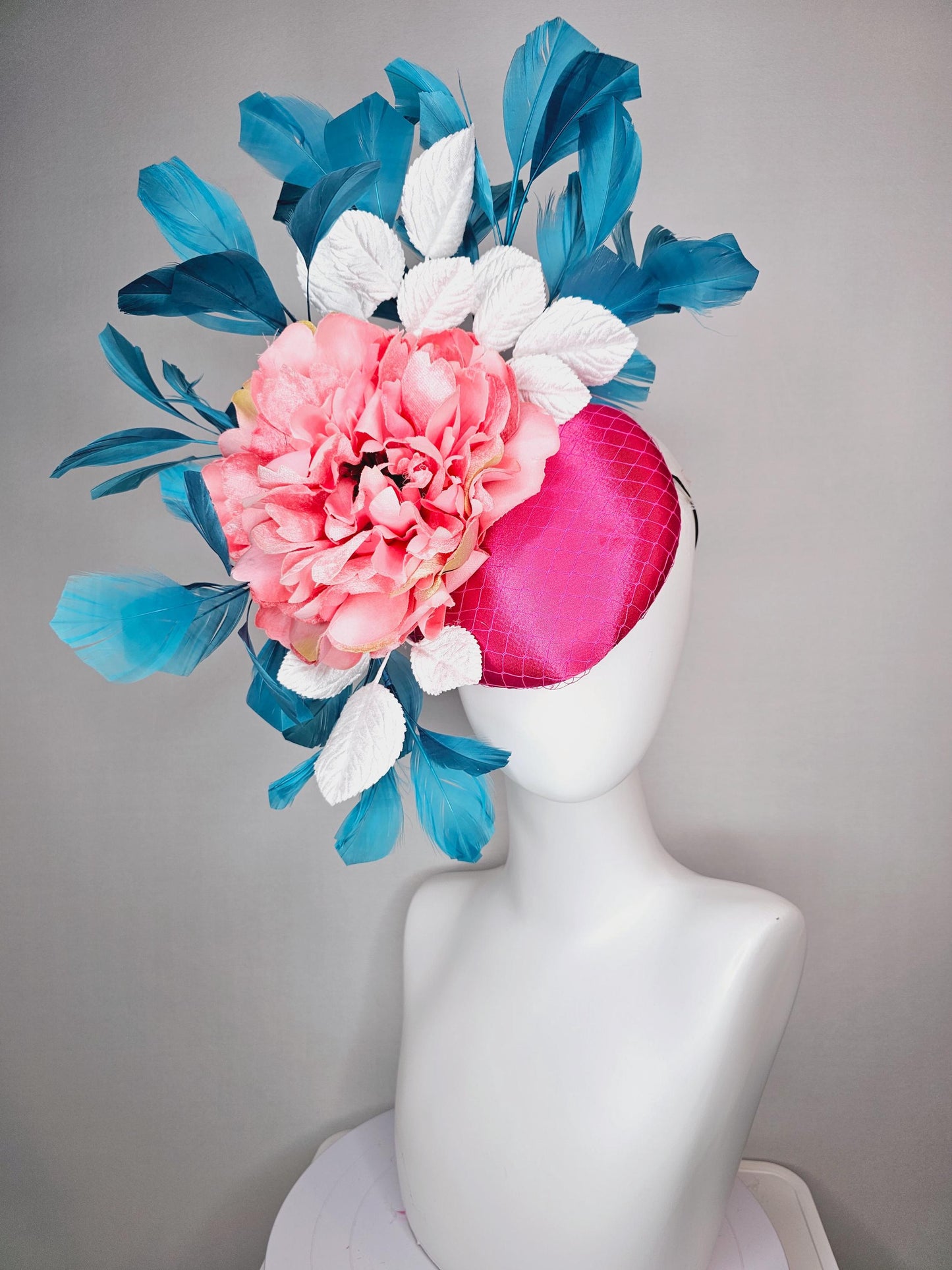kentucky derby hat fascinator hot pink satin with netting and light pink peony satin flower with white leaves and blue branching feathers
