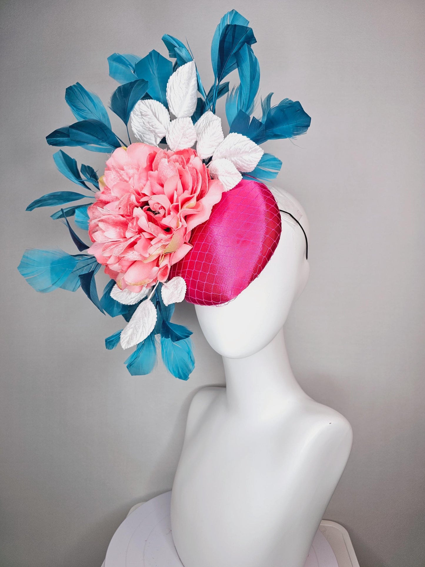 kentucky derby hat fascinator hot pink satin with netting and light pink peony satin flower with white leaves and blue branching feathers
