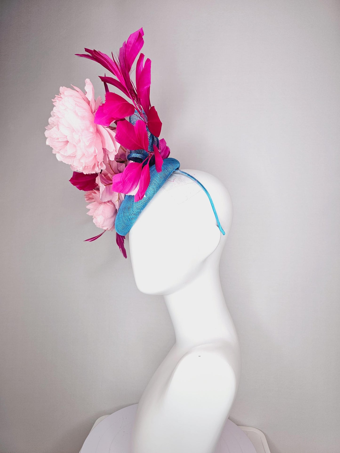 kentucky derby hat fascinator blue sinamay with bow and light pink peony satin flowers light pink leaves hot bright pink branching feathers