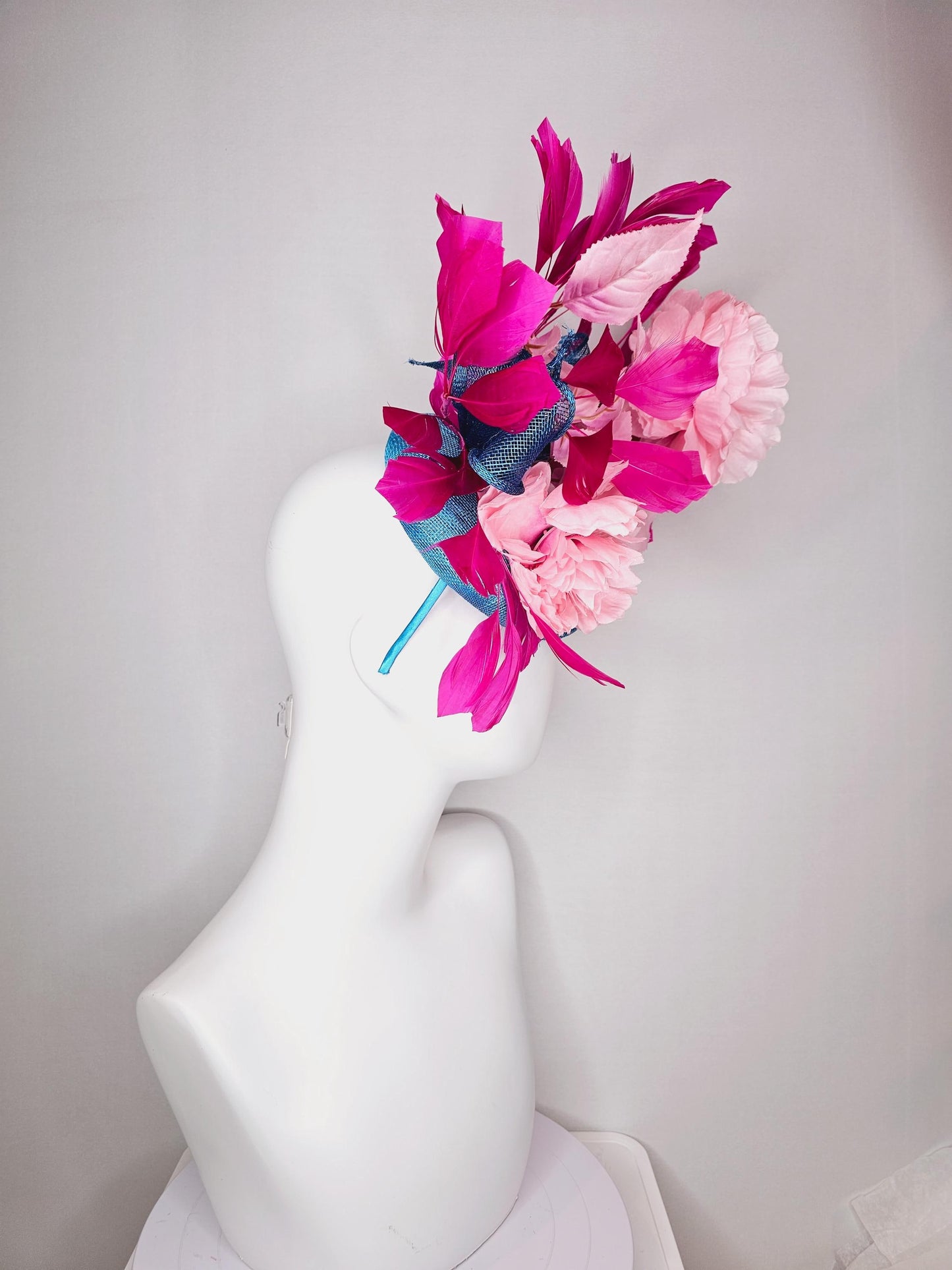 kentucky derby hat fascinator blue sinamay with bow and light pink peony satin flowers light pink leaves hot bright pink branching feathers