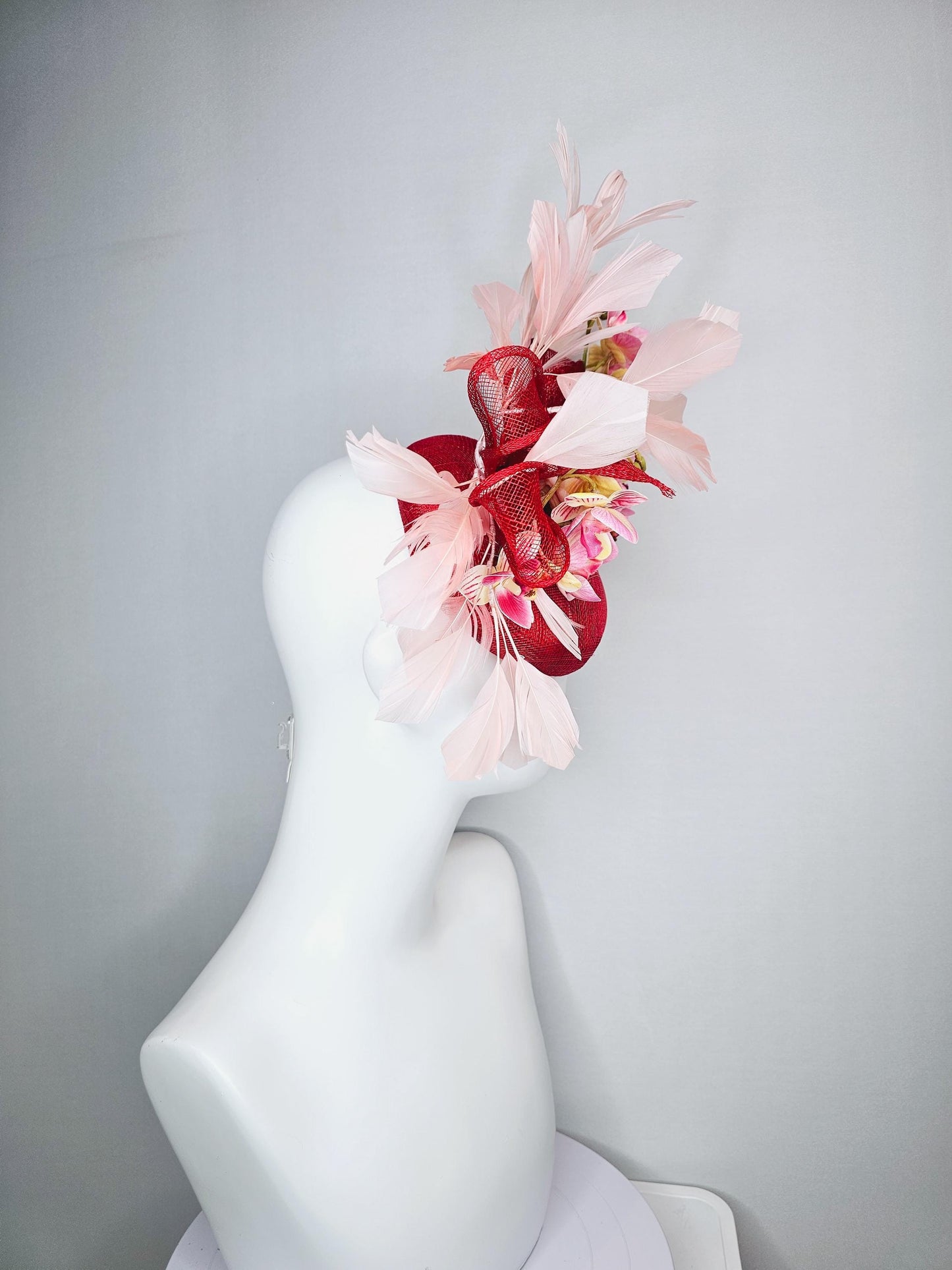 kentucky derby hat fascinator red sinamay with bow and white raspberry red pink satin orchid flowers with champagne pink branching feathers