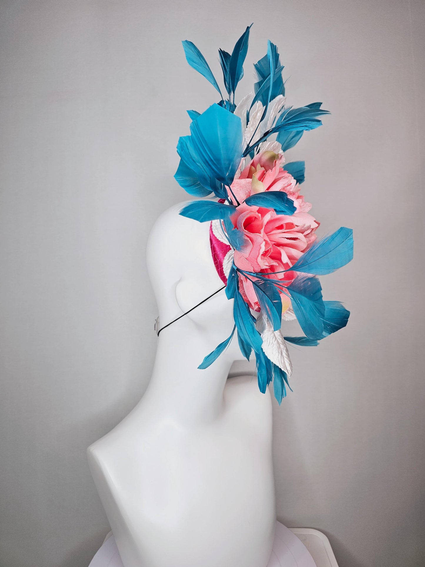 kentucky derby hat fascinator hot pink satin with netting and light pink peony satin flower with white leaves and blue branching feathers