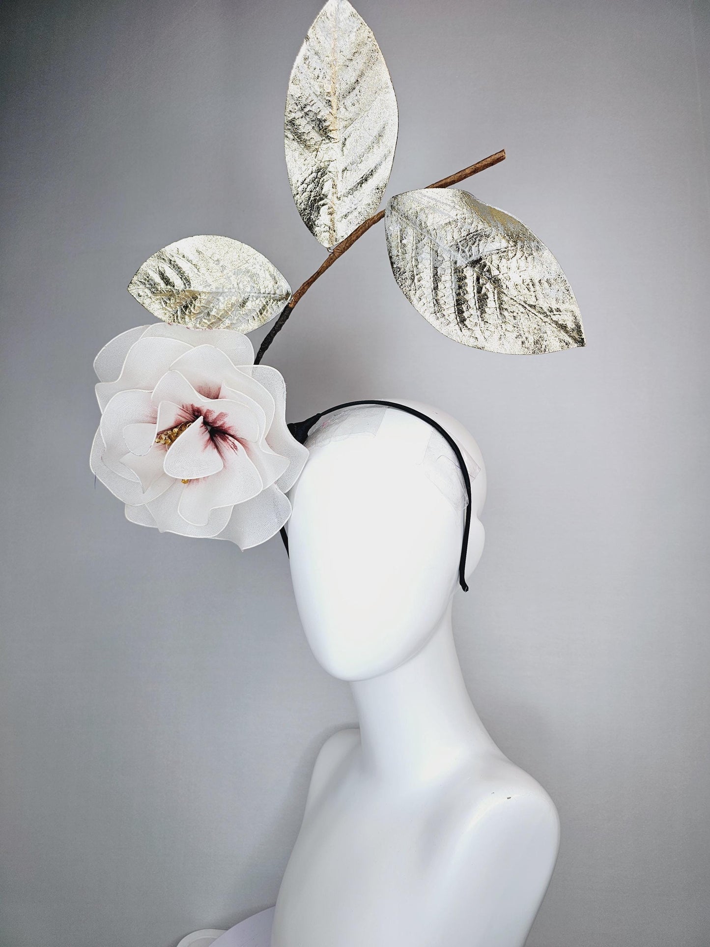 kentucky derby hat fascinator headband with large ivory white wire mesh flower on stem with large gold leaves